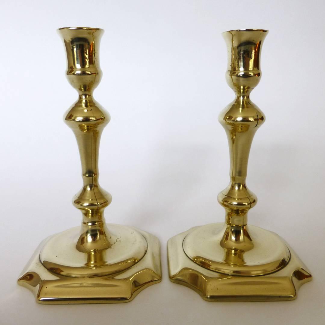 Pair of English brass Queen Anne candlesticks. Square base chamfered corners. Seamed shaft, circa 1740.
Age crack in one base.

Measures: Height 6 1/2?
Base 4? Square.