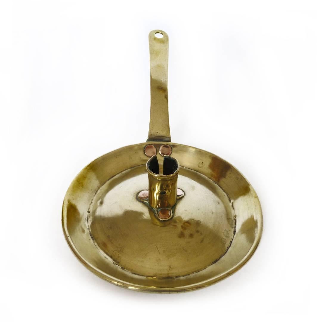 Dutch brass fry pan Chamberstick, circa 1750. Copper rivets.
Measures: Length 11 1/2? including handle
DOB 6?
Height 1 7/8?.