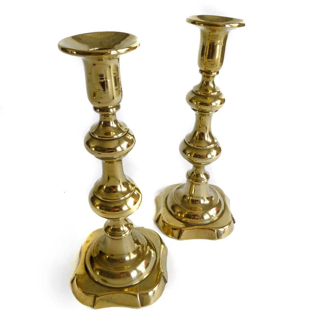 Pair of English brass chippendale candlesticks with “Push Ups.”
Scalloped base, circa 1790.
Height 8 1/2” base 3 5/8”.