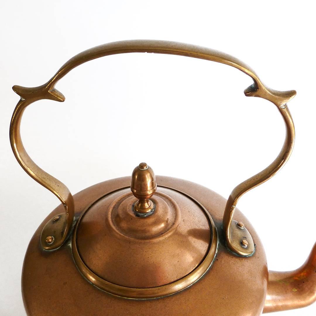 English copper kettle signed EVW for E. V. Wilkes, circa 1850. Acorn Finial. Cast Handle with inner and outer spurs. 7 pint capacity. Dovetailed. Letter J stamped on underside. Signed above spout. Measures: Height 11 1/2″, Diameter of base 6 1/2″