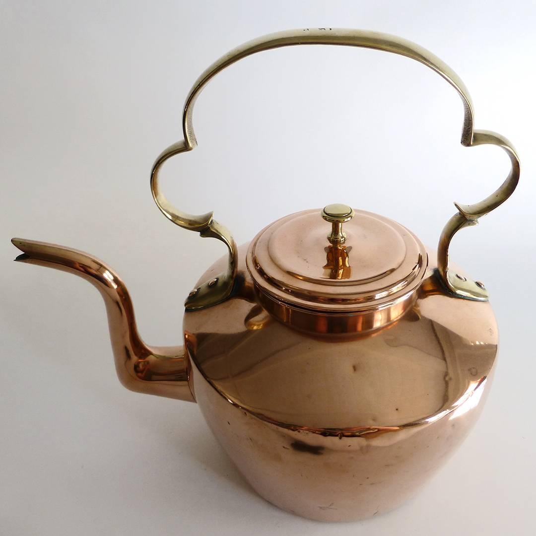 Large English copper teapot, circa 1820. Cast shaped handle. 12 pint capacity. Dovetailed. All original. Measures: Height 13″diameter of base 7 1/8″, width 13 1/2″.