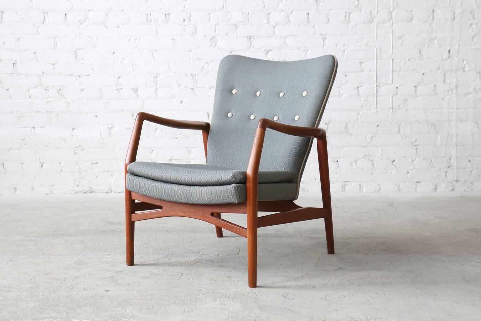 - model #215
- designed circa. 1955
- manufactured by Slagelse Møbelfabrik
- solid teak wood frame
- new pale blue Kvadrat Steelcut wool upholstery with contrasting sand coloured piping and buttons

A teak easy chair by Kurt Olsen for Slagelse