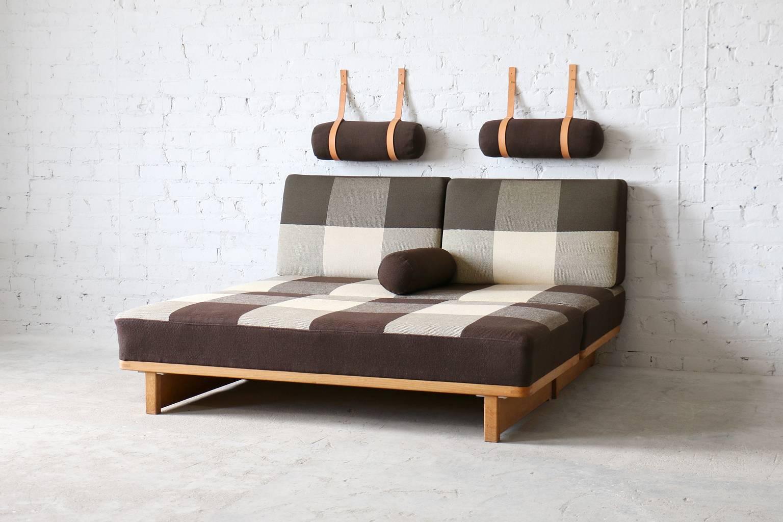 Manufactured by Fredericia.
Includes wall hung head cushions with saddle leather straps, back cushions and two extra cushions.
Spring mattress seats covered in original Cotil plaid fabric.
Solid oak wood frame.
Exposed joinery.

A rarely seen