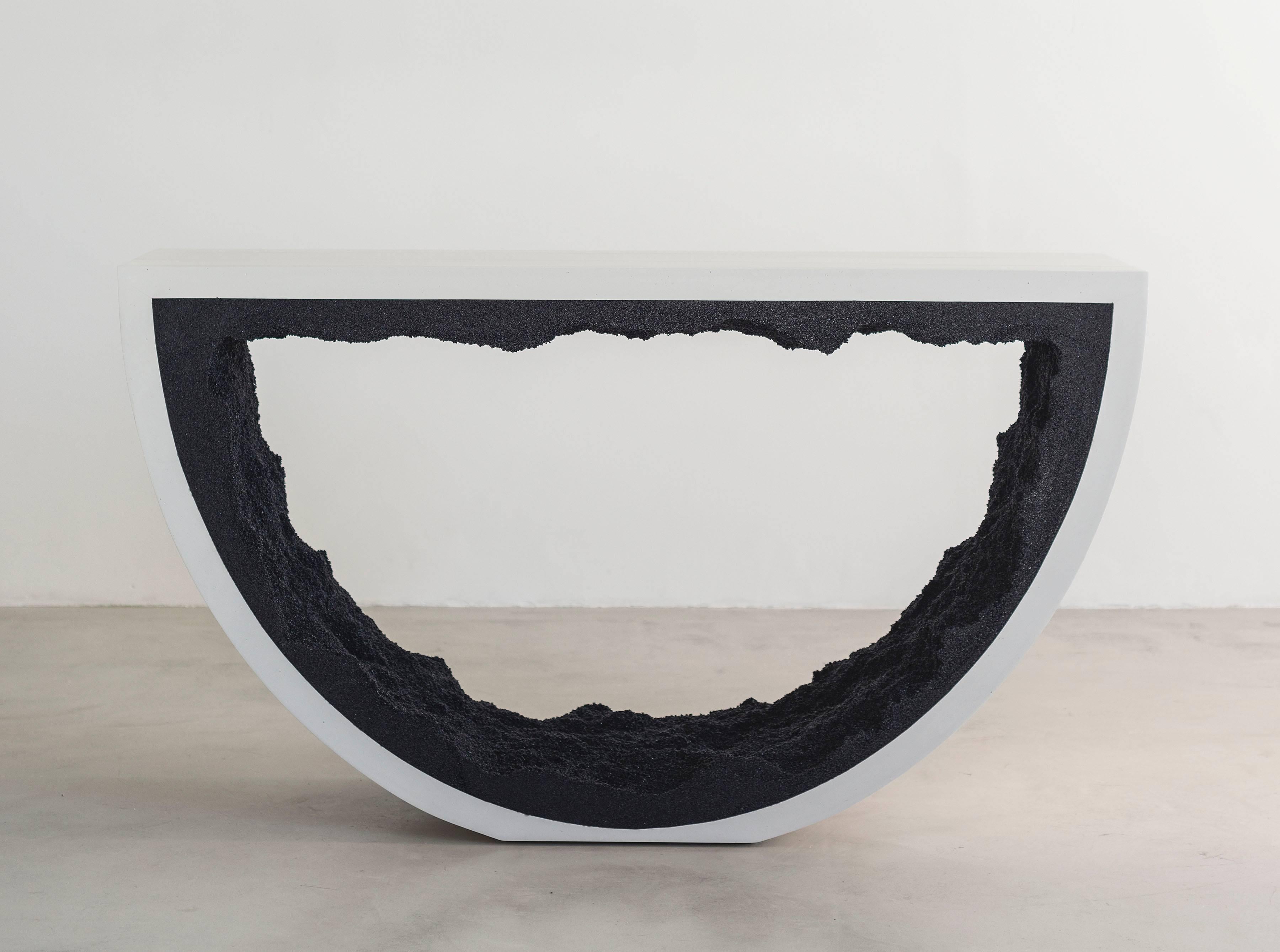 This Radius console consists of a hand-dyed white cement exterior and a black silica interior. The silica is packed by hand within the cement in an organic nature. 
Custom options available, please inquire with the studio.