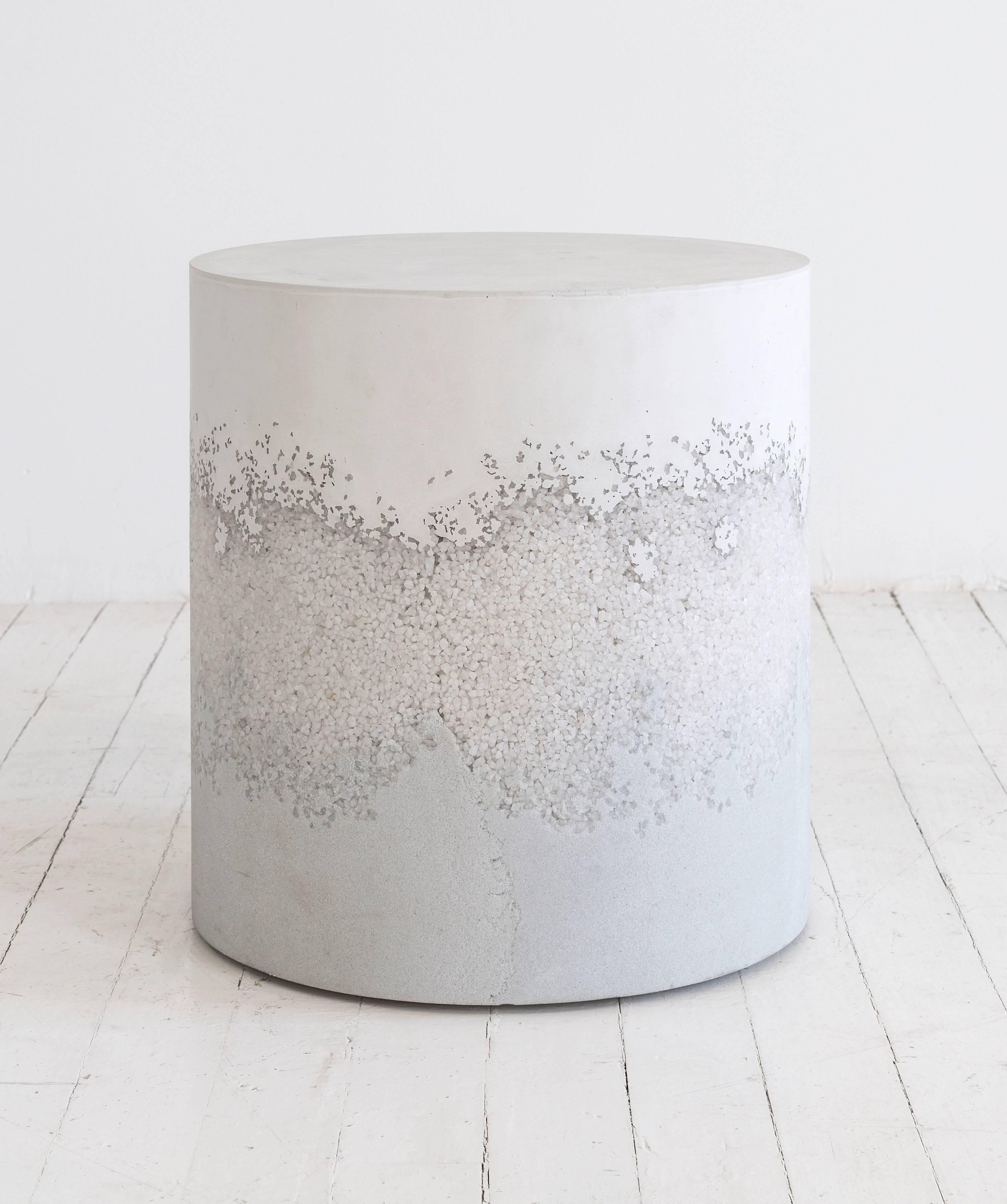 This made-to-order drum consists of a hand-dyed white cement top, a packed crystal quartz centre, and a packed powdered glass bottom. The cement is poured by hand over the aggregates, creating an organic blend between the materials. The piece has a