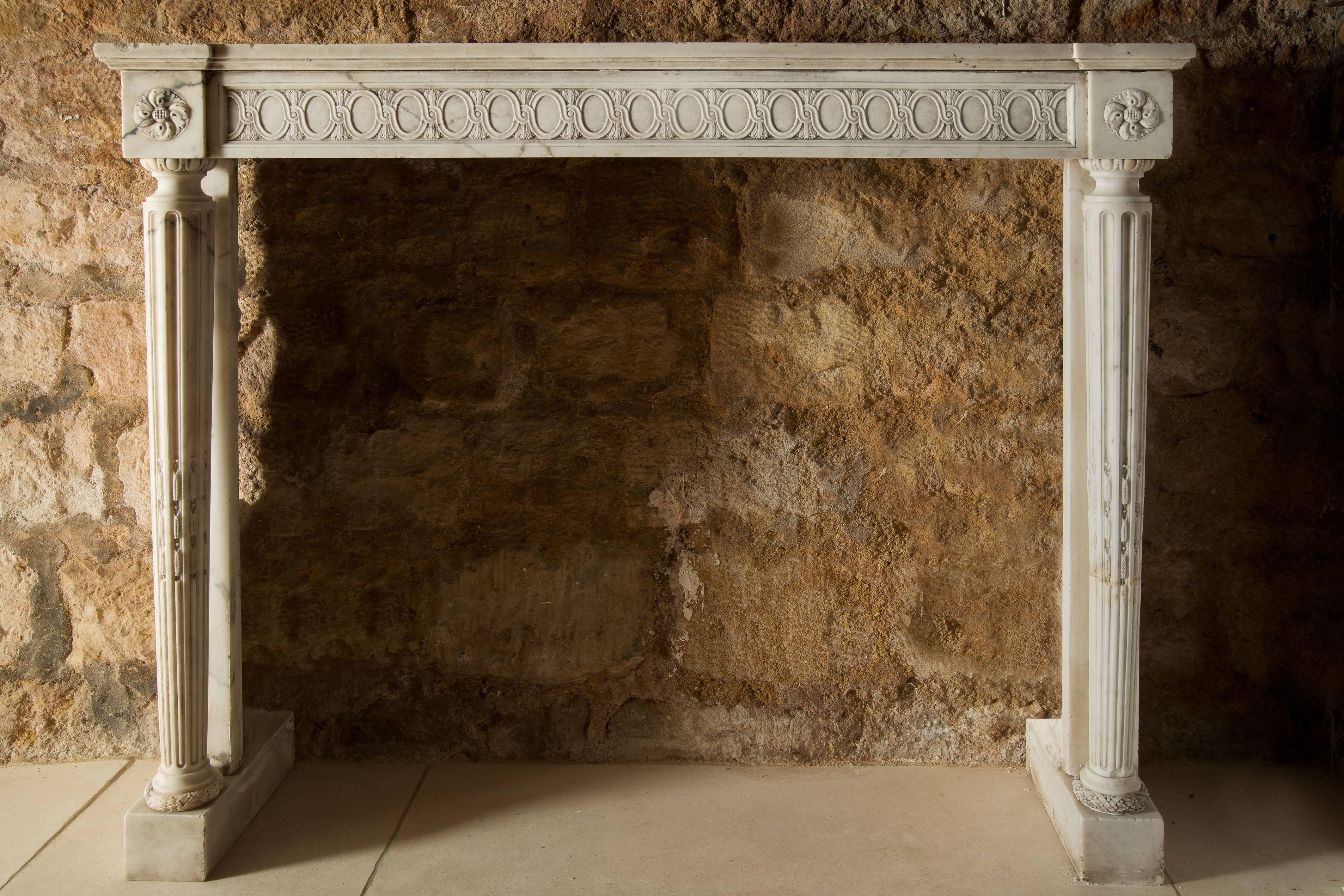 A beautiful white fireplace in marble.
This mantel is dated from the 18th century, its decoration is inspired by the Louis XVI style.
The marble of the fireplace is carved on its shelf and both columns.
 