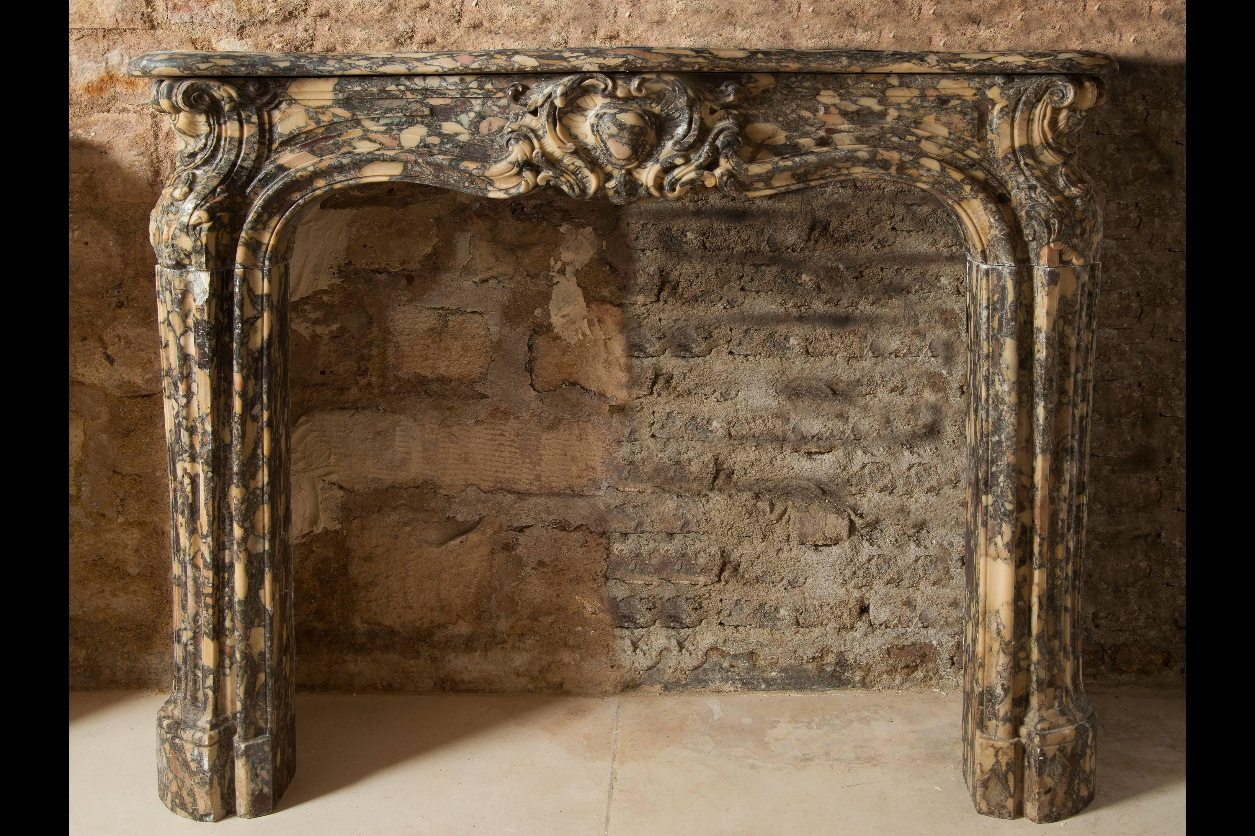 Carved Louis XV Period Brown Marble Fireplace For Sale