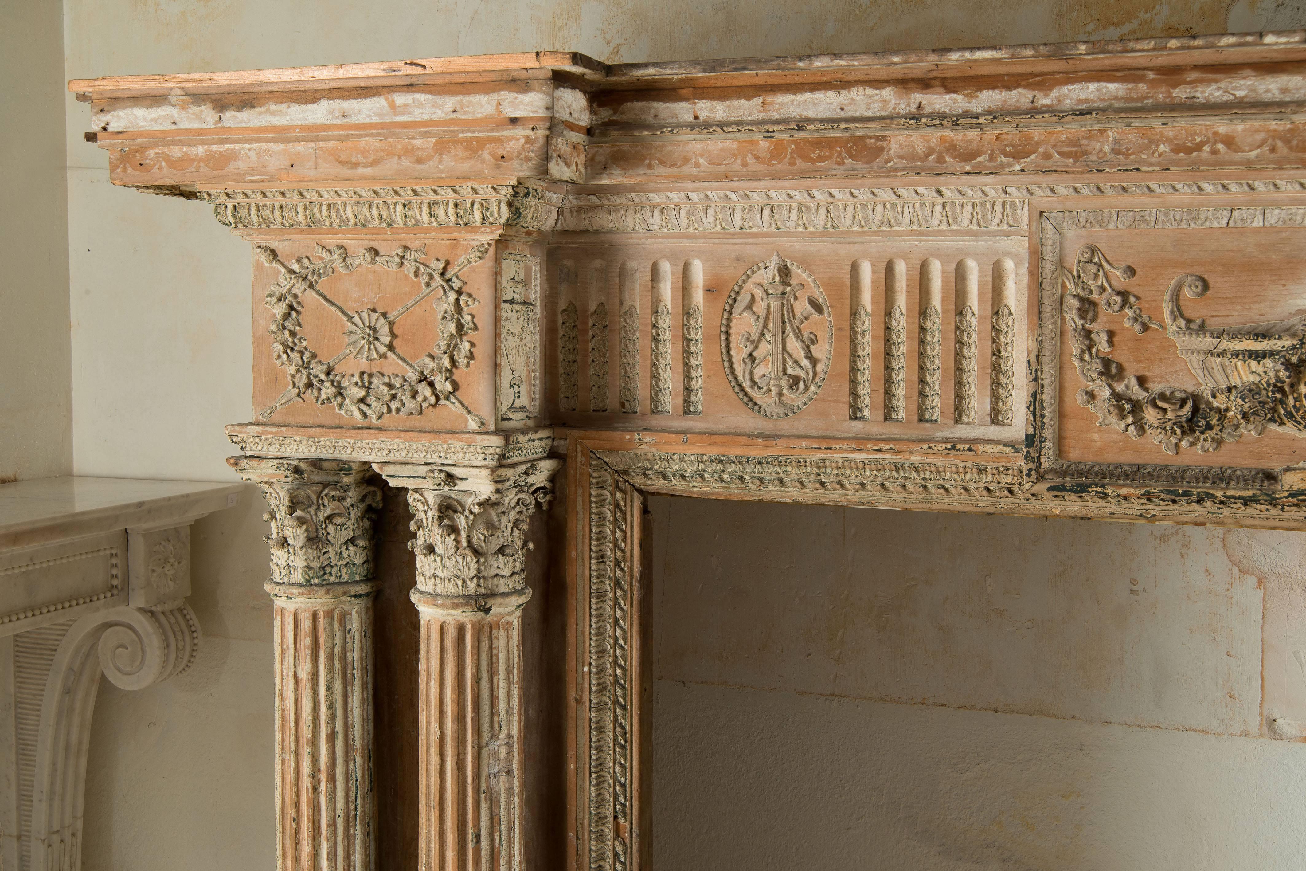 Beautiful English fireplace in wood with columns and applied ornaments. 
In the pure Adam style.
 
