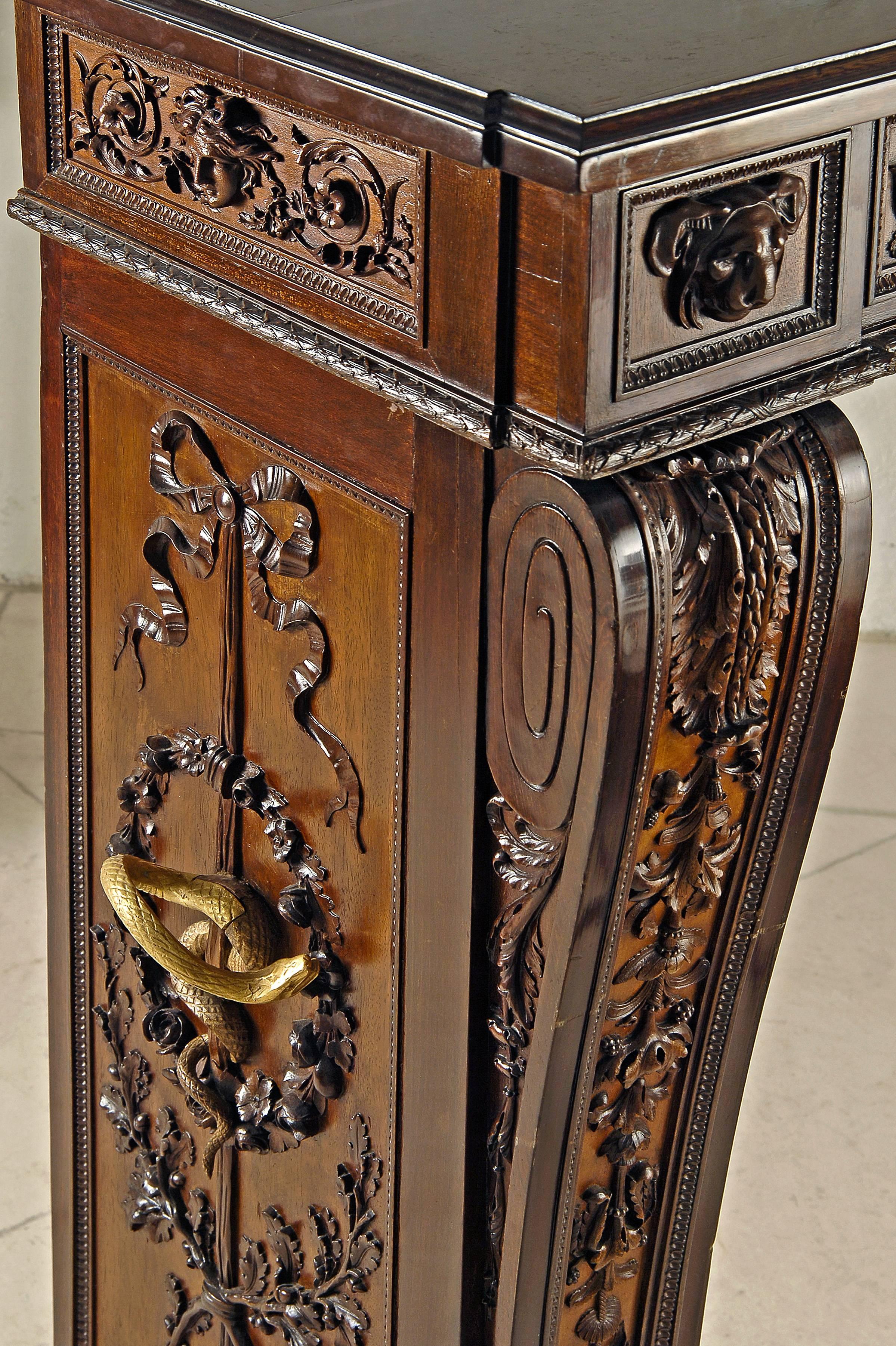 Fireplace in Mahogany beautifully carved with Lion heads, ribbons and leaves on its shelve and both jambs.
Copy of a fireplace in marble of Carrara and gilded bronze made for Louis XVI and Marie-Antoinette at Versailles.