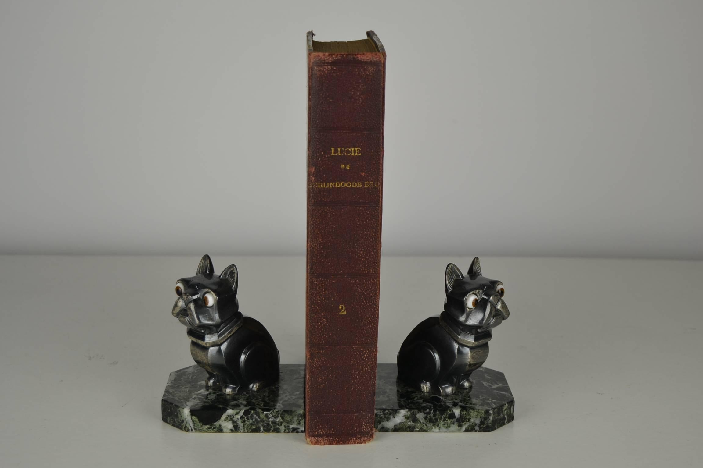 Beautiful pair of French Art Deco bookends with sculptures of French Bulldogs.
Made by the French artist Hippolyte Moreau and both signed H.Moreau.
Two caricature dogs in silvered metal with big unusual white, butterscotch and black glass eyes.