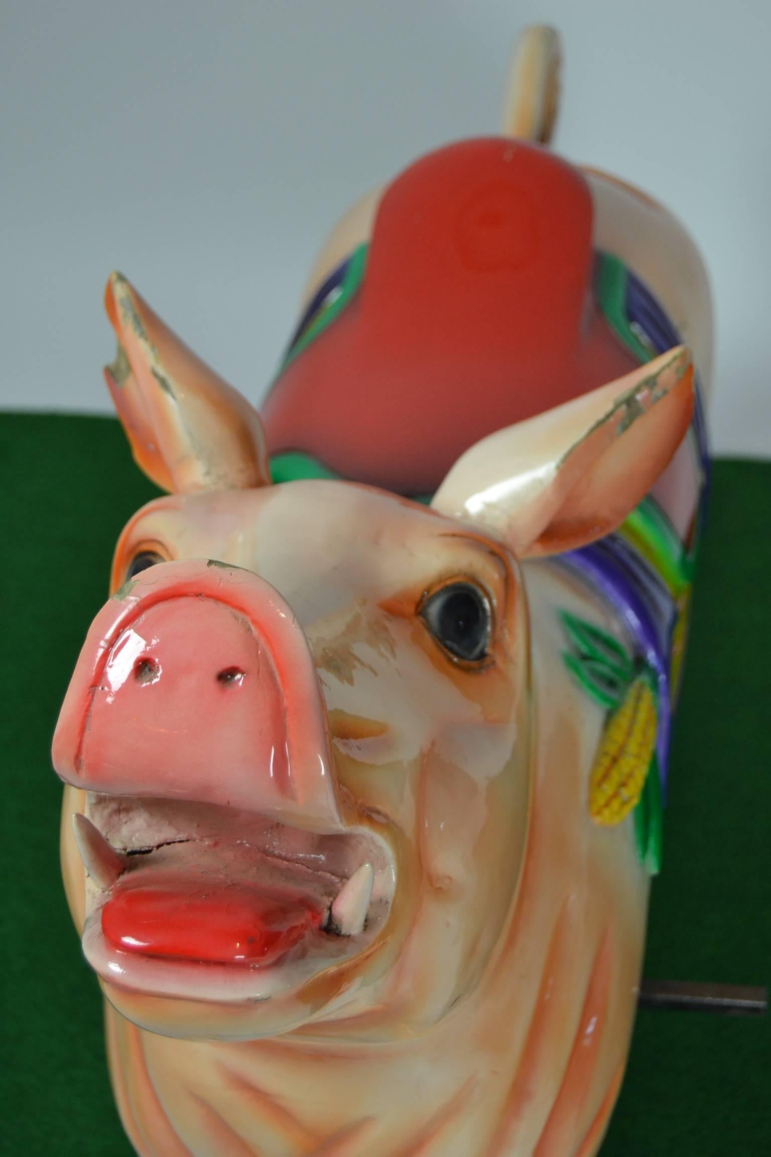 A carved wood carousel animal.
Full size vintage carnival ride pig on a metal base for child or adult.
Carver unknown, comes from a Dutch carousel ride, late 20th century.

Nice piece of decoration in a Butcher's shop or restaurant in