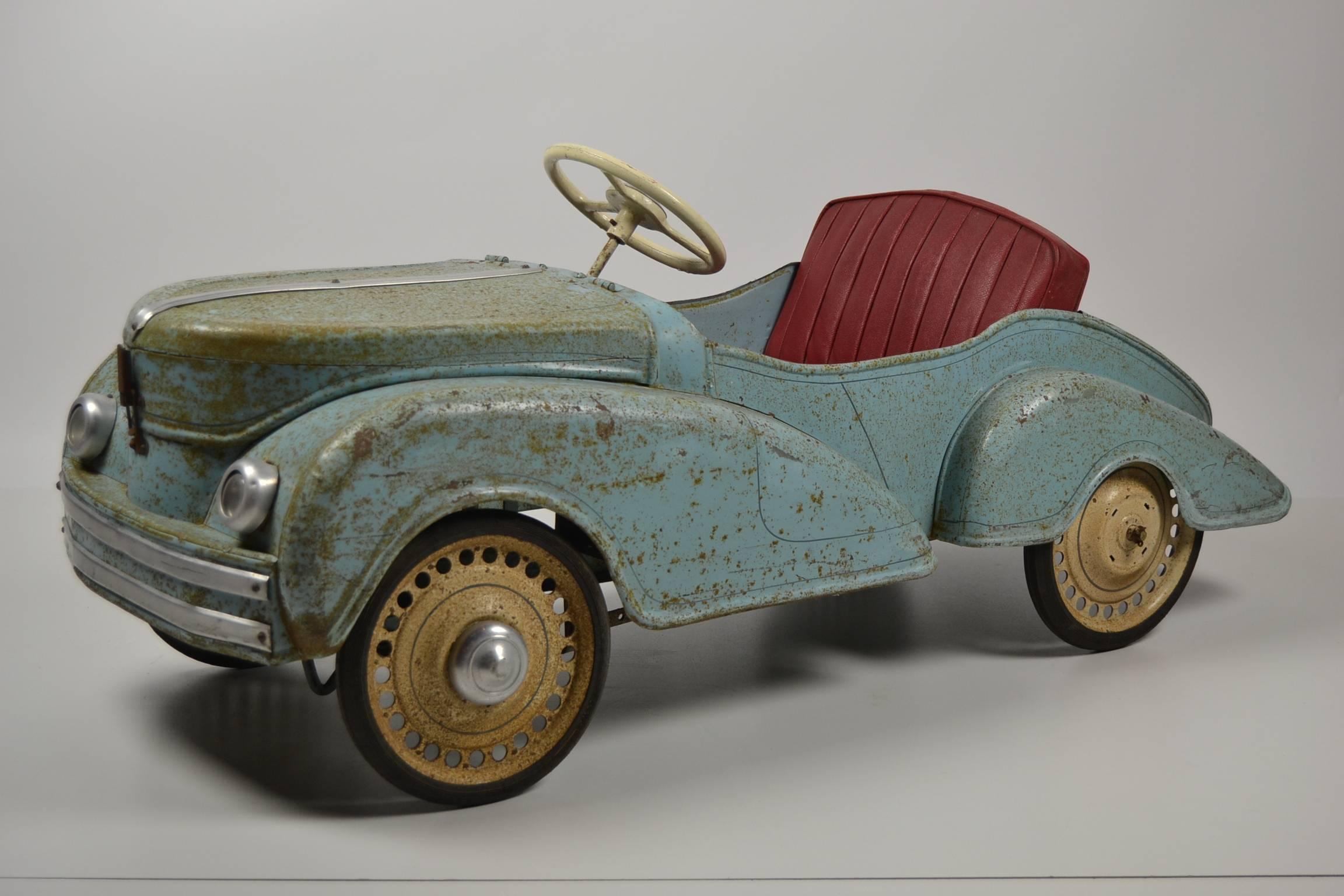 Awesome vintage pedal car with nice old blue patina. 
Solid car made of metal. Manufactured in France, circa 1950.
 