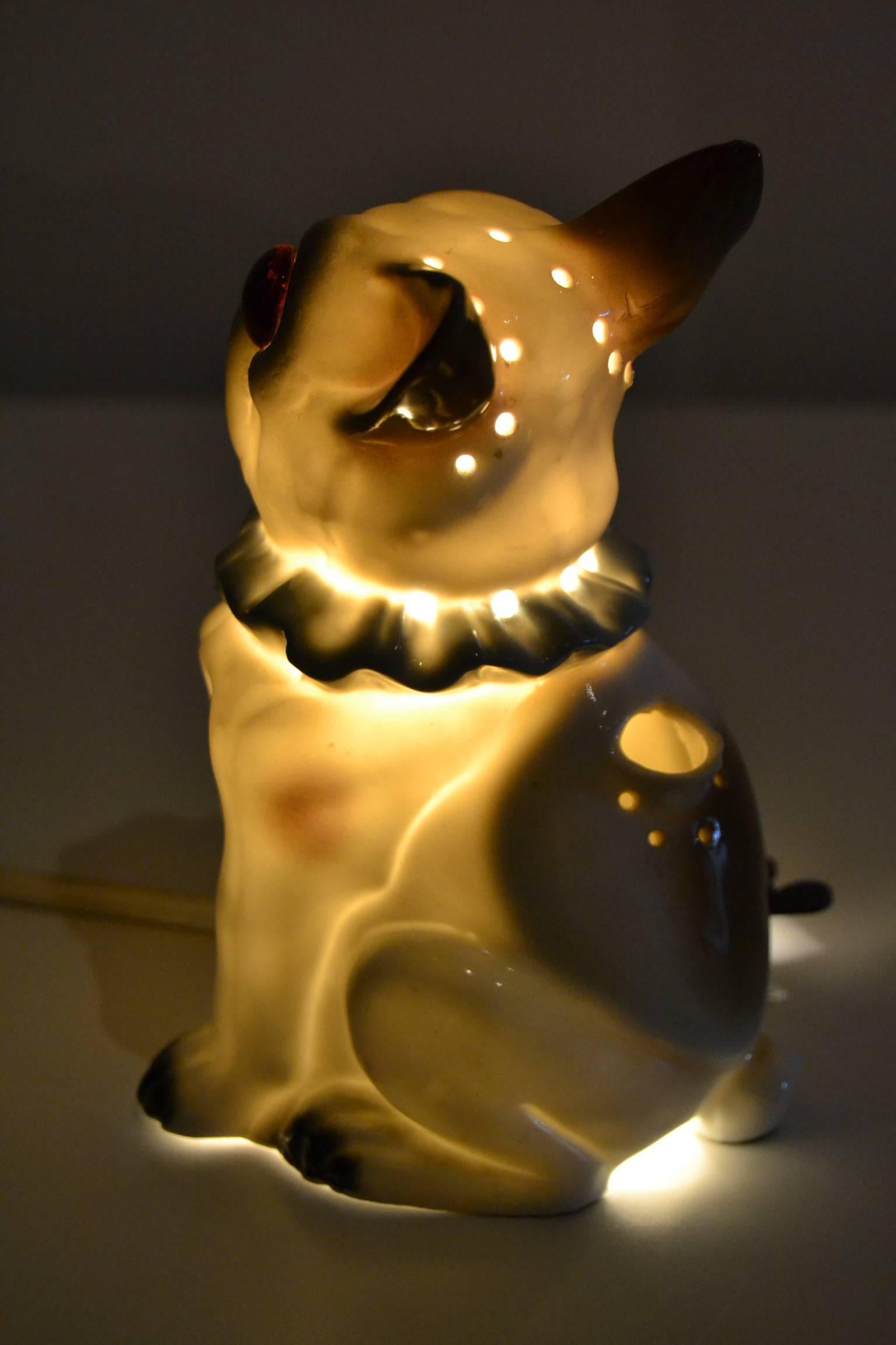 Art Deco Porcelain French Bulldog with amber glass eyes.
1920s Perfume lamp - nightlight.
German Porzelann  Schauberg Bavaria with number 66.