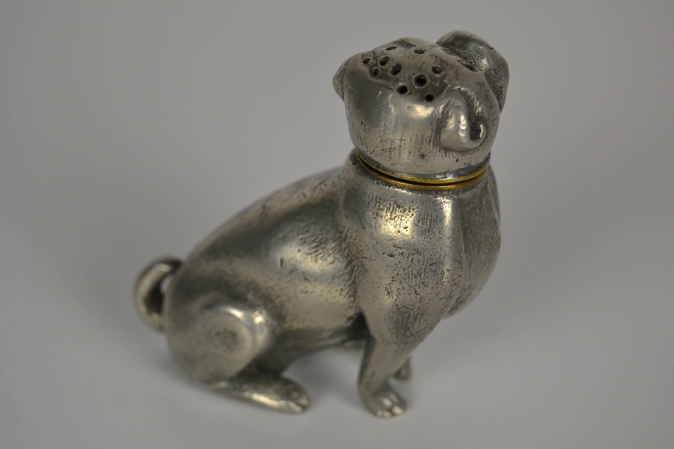 Antique pounce pot, Sander, sand duster,
were used to dry ink on paper before blotting paper became available in the early 1800s.
Dog figural pug.
Made of silver colored metal.
Looks like a vintage pepper pot or pepper and salt shaker.
    
  