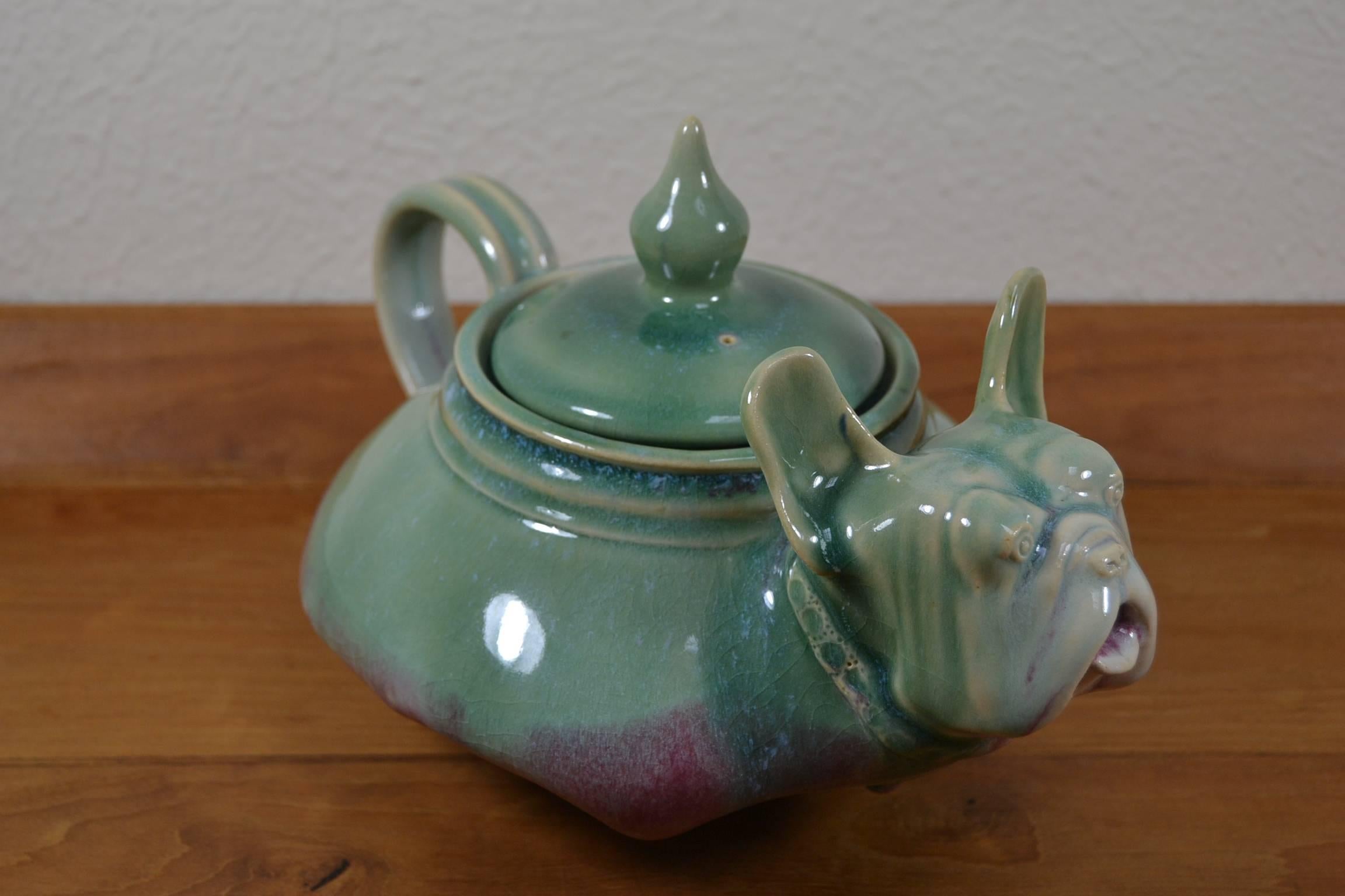 Unique vintage teapot with dog figural.
Stunning design of teapot with the head of a French Bulldog.
Made of glazed ceramic.
Signed.
Nice combination of the colours green and bordeaux / dark rose (on the pictures he looks more blue).
Rare