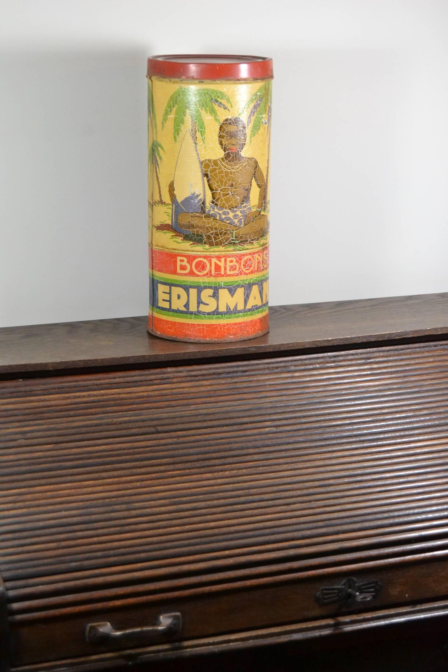Art Deco Litho Candy Tin Box with a beautiful design of a seated Negro Boy - Black Boy under a Palm Tree , holding a Sugar Cane.  
This round tube Tin Storage Box was made for the Bonbon Company Erismann , 
which was seated in Geneva CH - Bordeaux