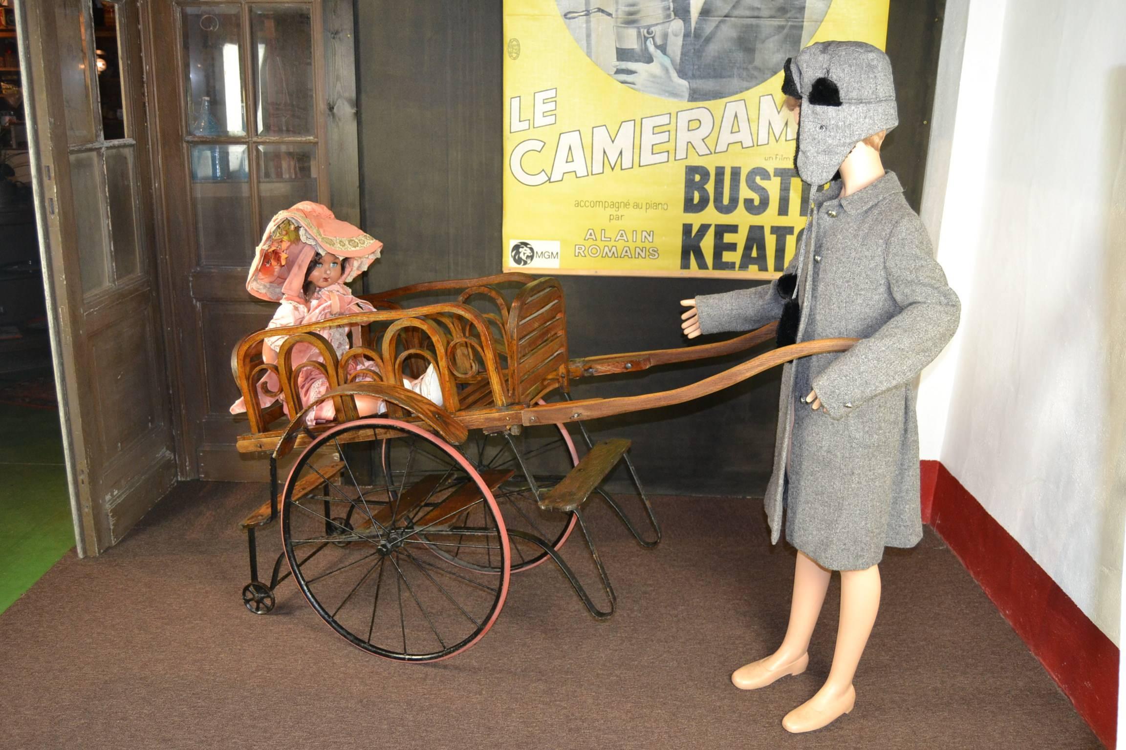 Exceptional Antique wooden TANDEM PERAMBULATOR - pram . 
Made by the French company: Eug. Vincent & Cie , Boulevard St Germain , Paris, France between 1900 - 1920. This company was specialised in fabrication of children carriages and wheelchairs.