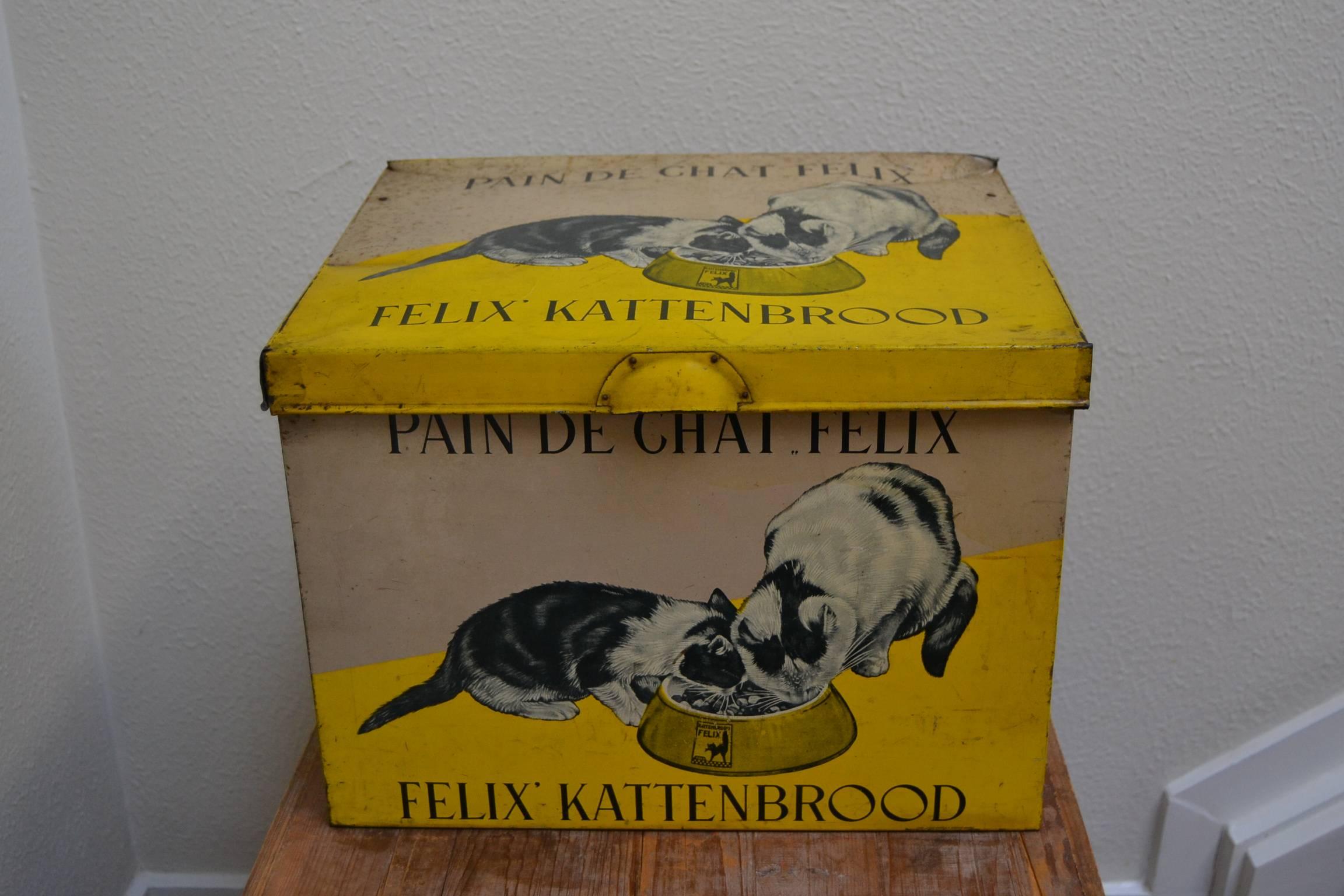 Very special rare antique tin box for cat food, circa 1940.
Felix Kattenbrood, Pain de Chat Felix, Cat Bread Felix.
Awesome lithographic yellow tin box with beautiful designs of cats.
This vintage tin will go certainly to a cat lover. 

The