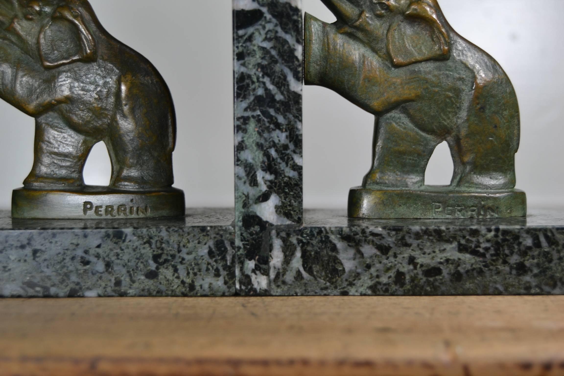 Pair of French Art Deco - Art Nouveau Elephant bookends on green veined marble, circa 1930. 
Bronze elephants on black - green - white marble both signed Perrin.
Both still in very good condition.