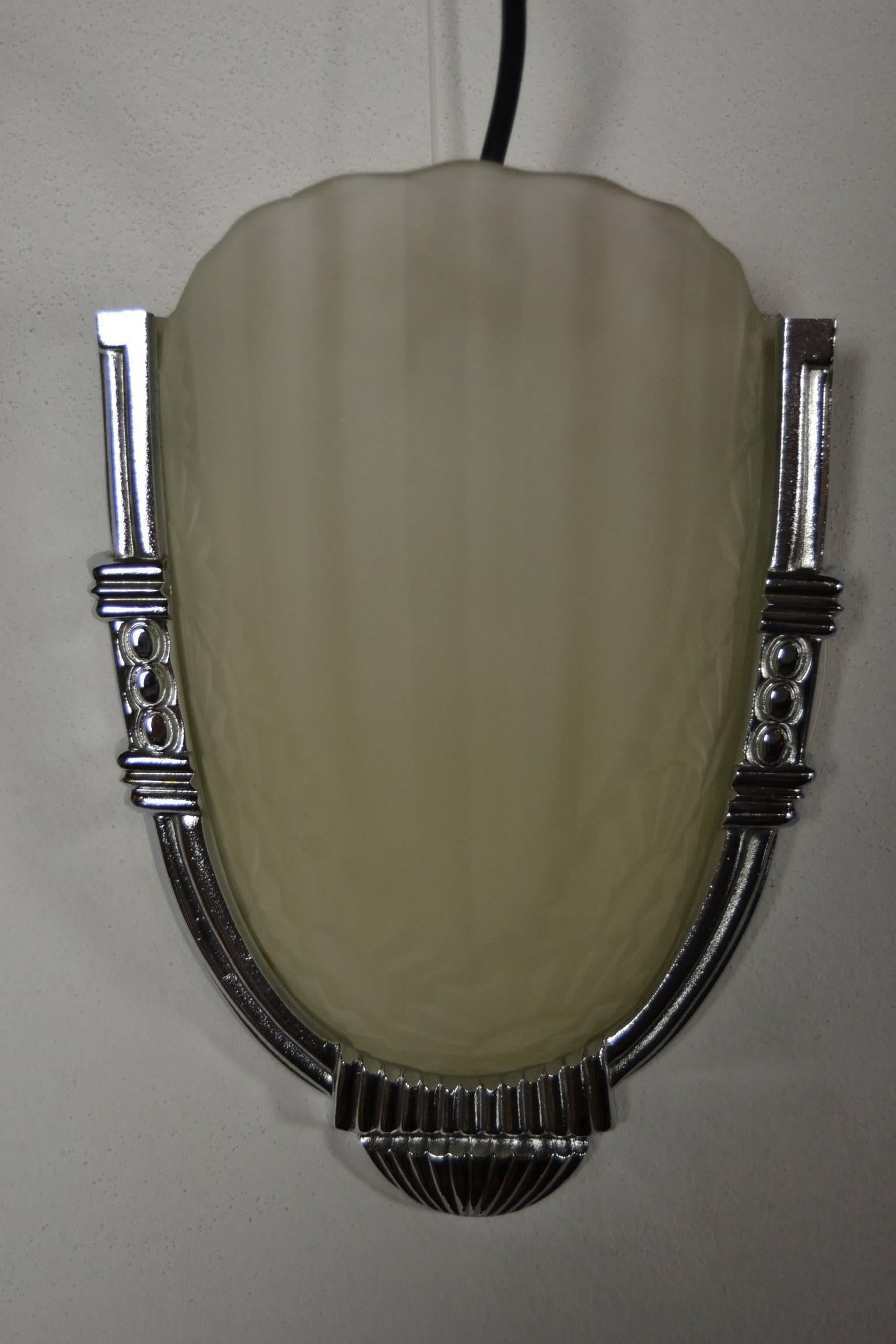 Set of four French Art Deco wall sconces by Degue.
Molded clear frosted glass shades decorated with geometric flowers - floral motif and polished silver bronze frames.
All in very good used condition.