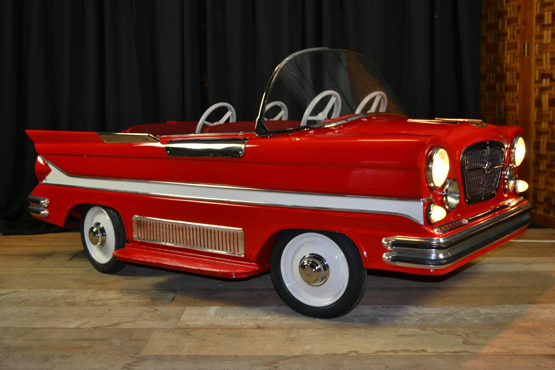 Spectacular vintage metal Carousel - Fairground Car. 
Type: Dodge.
Four-seat kid's car completely handmade for carousel.
Produced and designed in Belgium by L'Autopède from 1963-1973.
Recently fully restored. 
Awesome piece for decorating