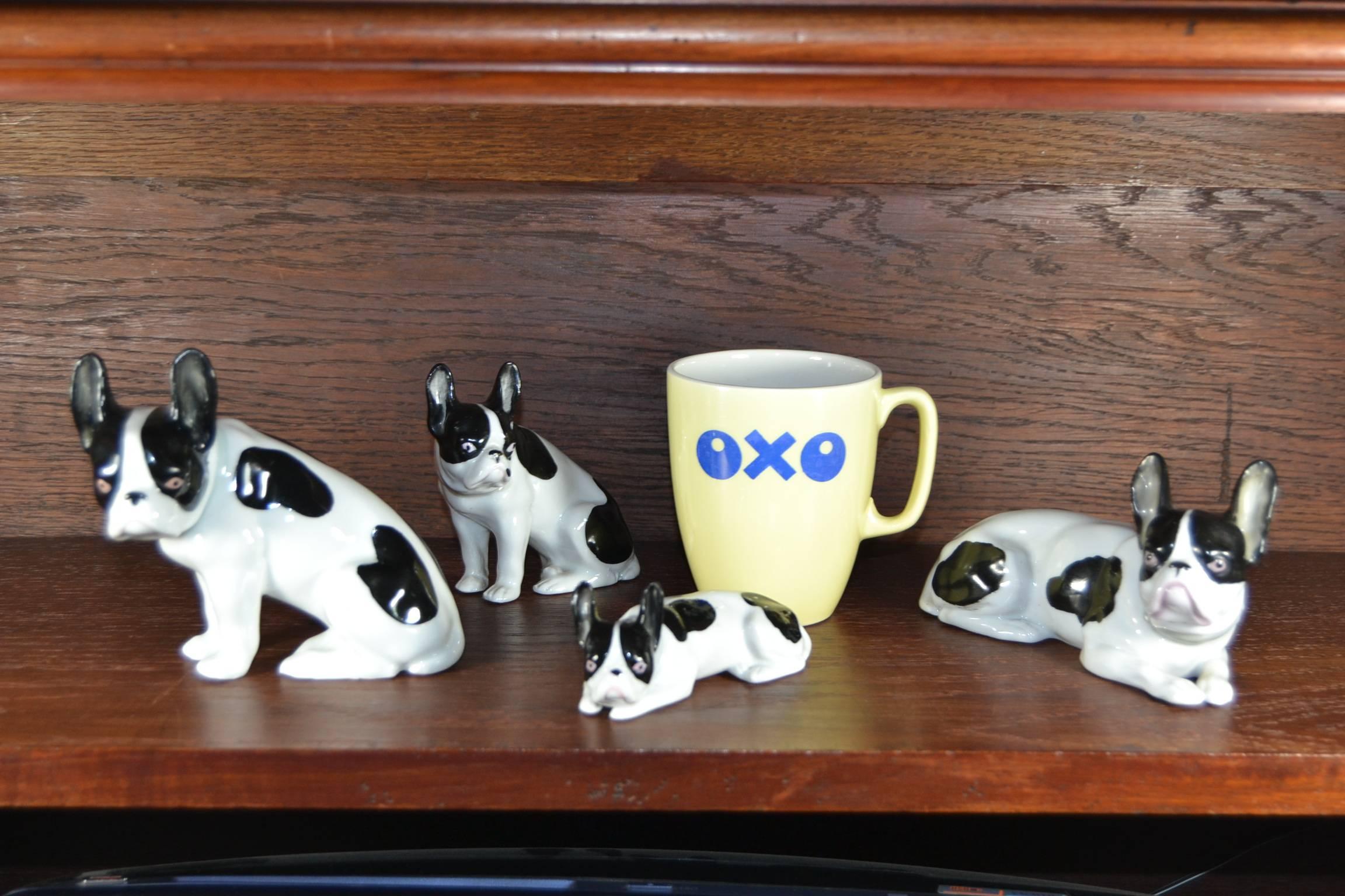 Antique German porcelain dog figurines, early 20th century.
Black and white bullies with grey collar in the style of Heubach Porcelain.

The four French Bullies have different sizes and positions. 
From left to wright - family picture with oxo