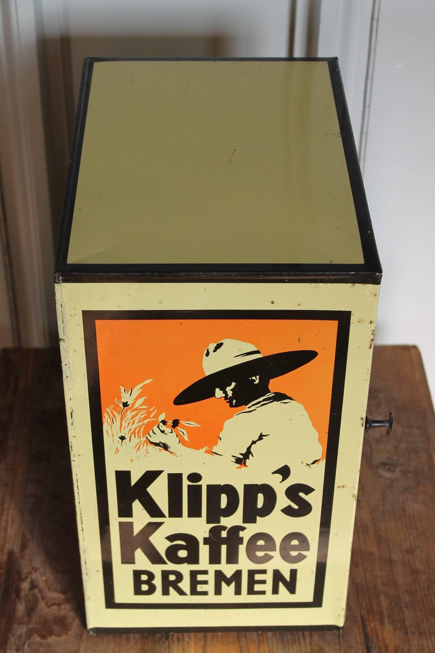 Vintage coffee shop display for Klipps - Klipp - Kaffee Bremen, Germany.
This counter roaster tin box with door was made between 1930 and 1950.
Can closet - cupboard was made for the coffee vendor - grocer to use as a counter display for the
