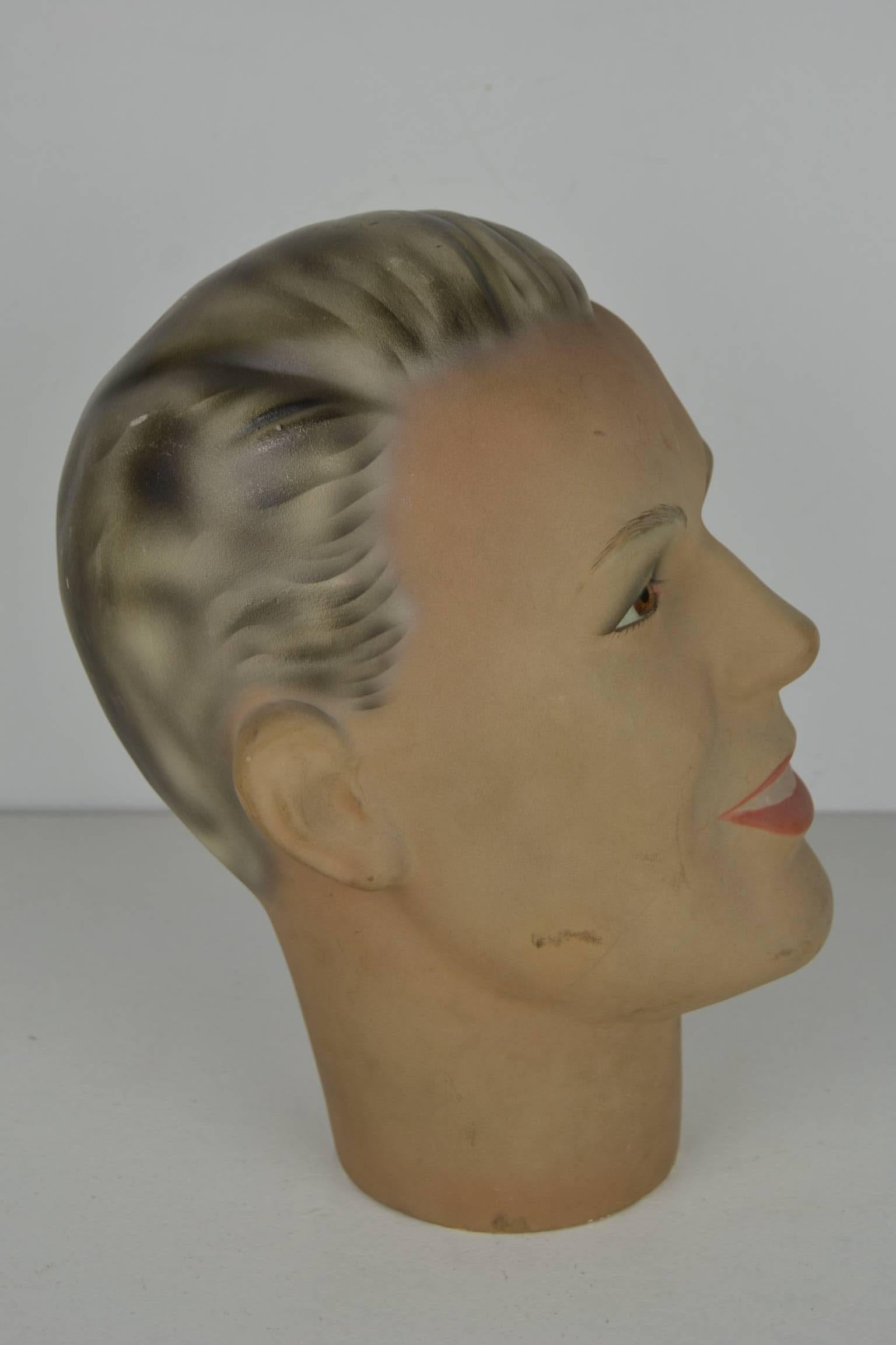 Vintage lifesize plaster male mannequin head with modeled hair and real glass eyes. He has a lovely smile on his face that makes him very charming.
Dates from the Art Deco period - 1920s - 1930s - not signed - probably French.
Still in very good