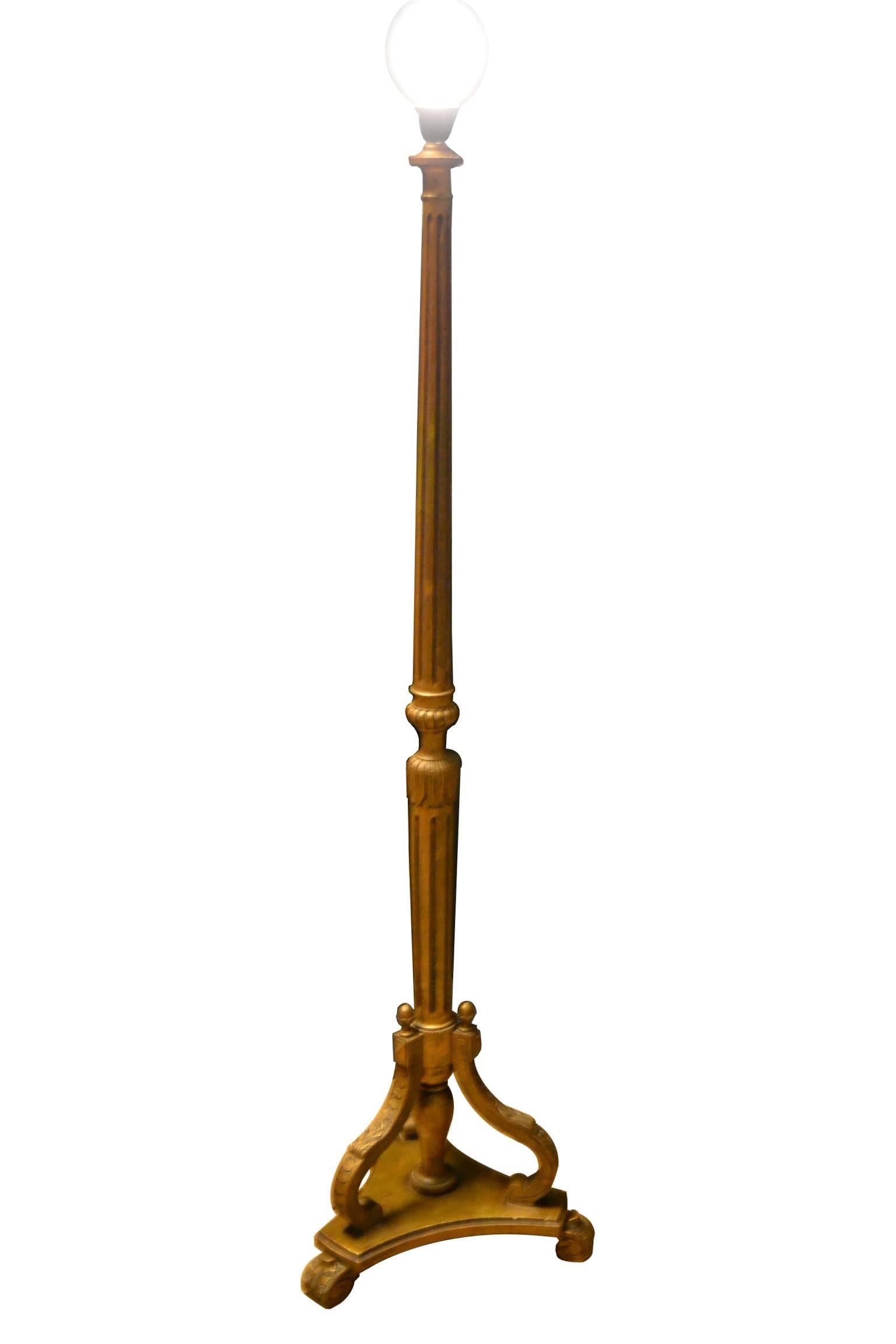 Vintage French Giltwood Floor Lamp. 
A Carved Tripod Base radiating from a central fluted column boasting Leaves. 

Charming Recency Style Light from the 20th Mid-Century period.
This floor lamp has been rewired.
Comes with a vintage - new old stock