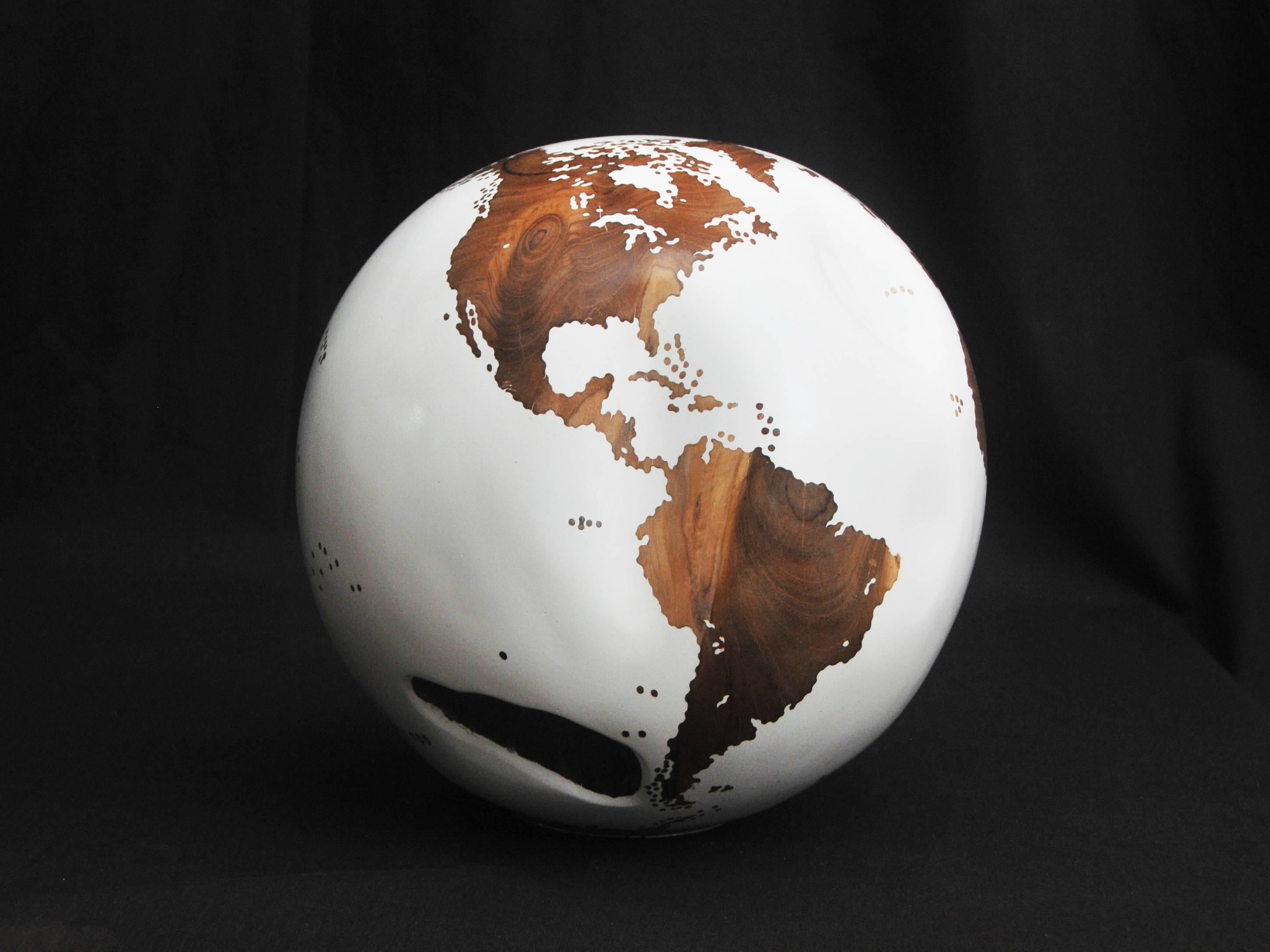 One of a kind globe
Hand-Carved in a solid piece of teak root 
Finishing: White lacquer
Mounted on turning base.