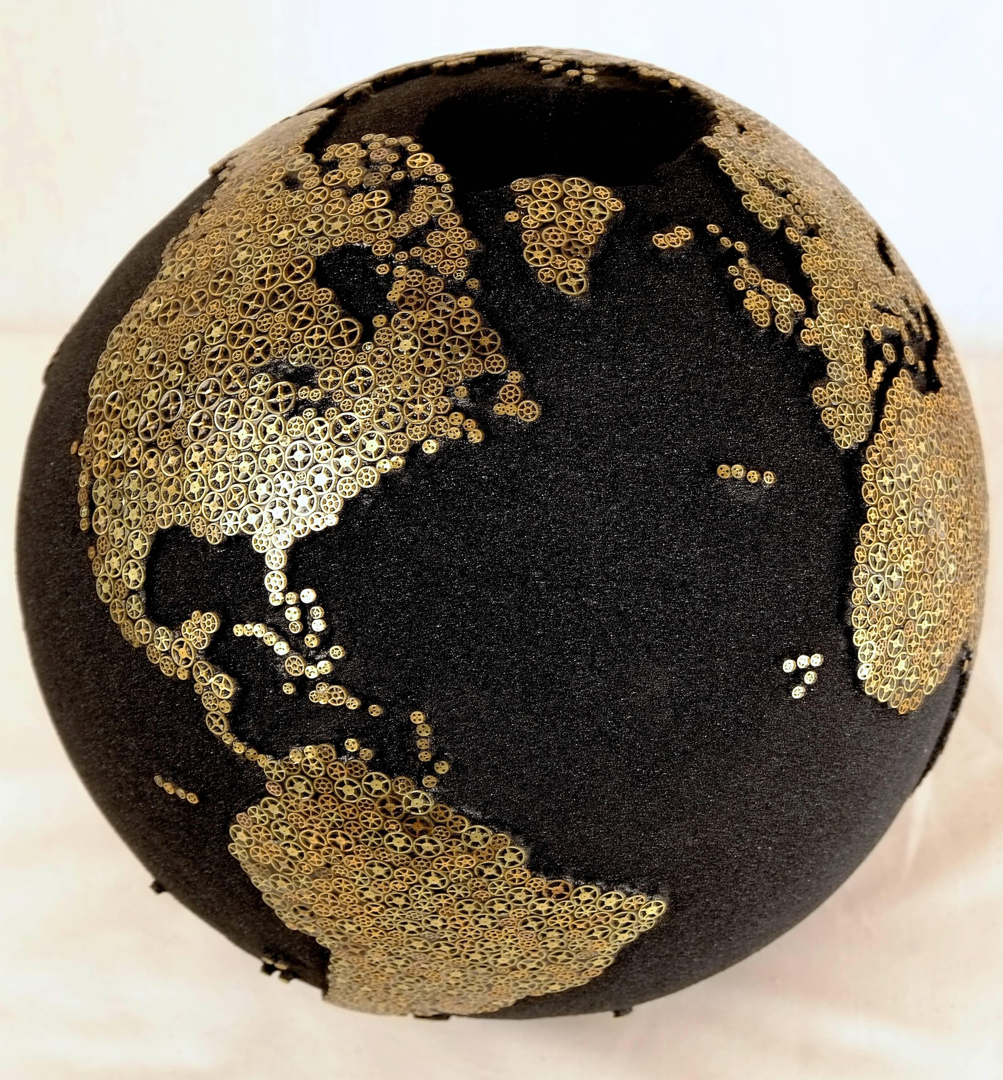One of a kind 
Wooden teak root globe 
Diameter 30 cm 
Turning base 
Hand-carved 
Volcanic black sand 
Thousands watch mechanisms inlayed.
 