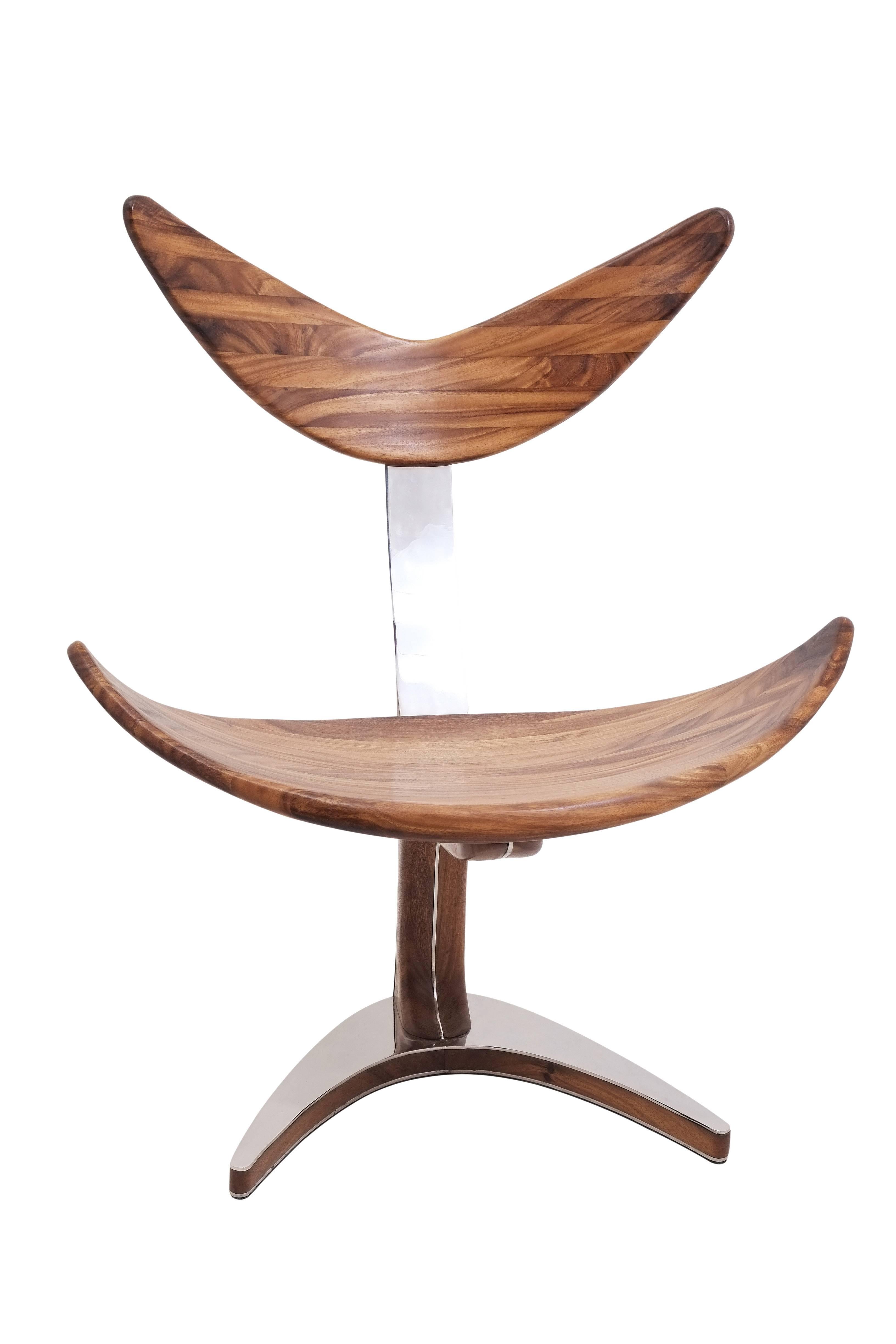 Elegant and stylish chair inspired by whale tail made of solid suar wood (tropical acacia) with mirror polished stainless steel.
Ottoman included.

Dimension: 
Seat height 42 cm / 16.53 in
Base legs 45 cm by 60 cm / 17.72 in by 23.62 in
Total