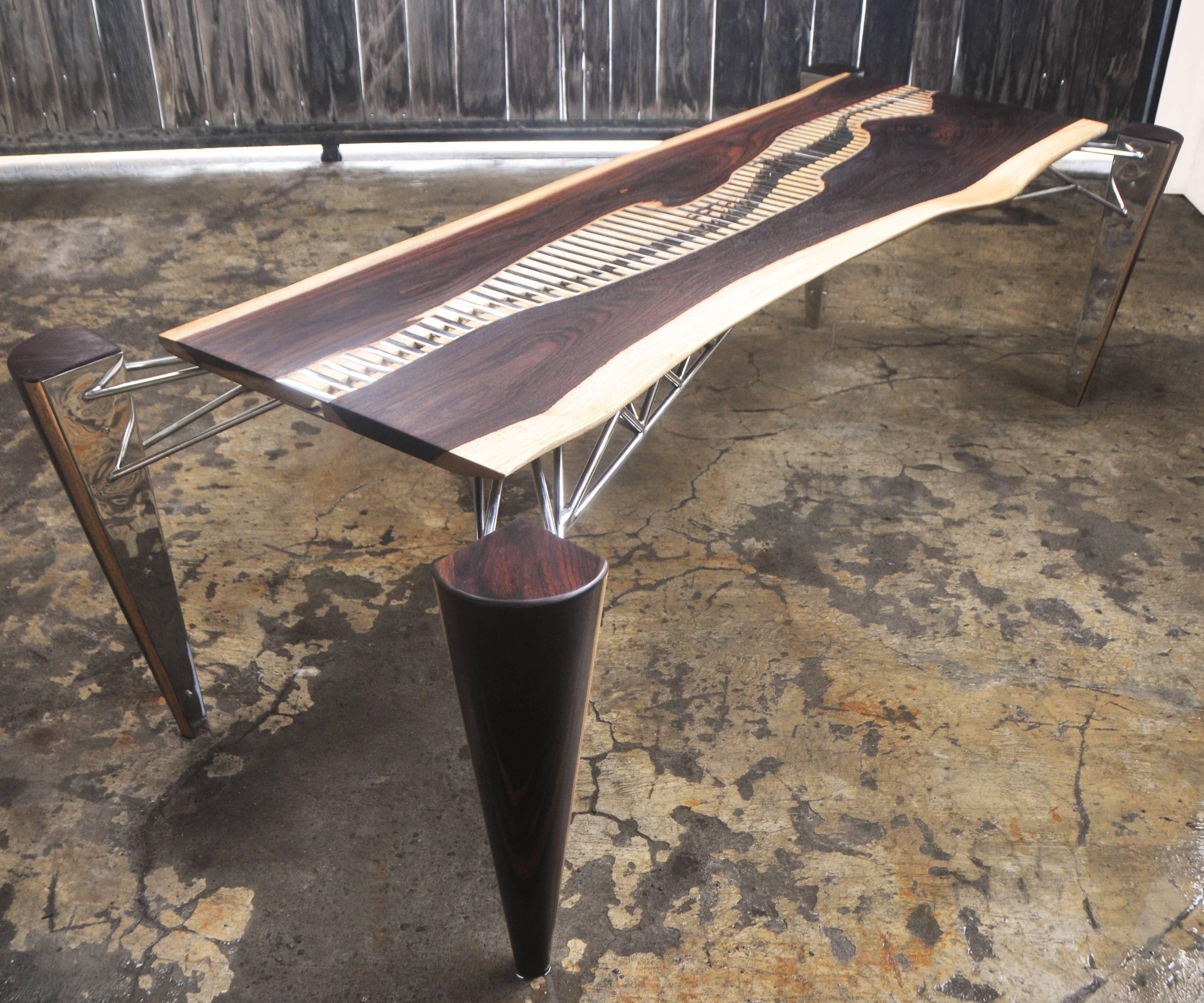 Exceptionally stunning and unique table designed by Bruno Helgen. Inspired by Mahakam River (Mahakam is the East Borneo longest River).
This piece is made of rosewood and stainless steel with mirror polished finishing.

Dimension:
Outer: 236 (D)