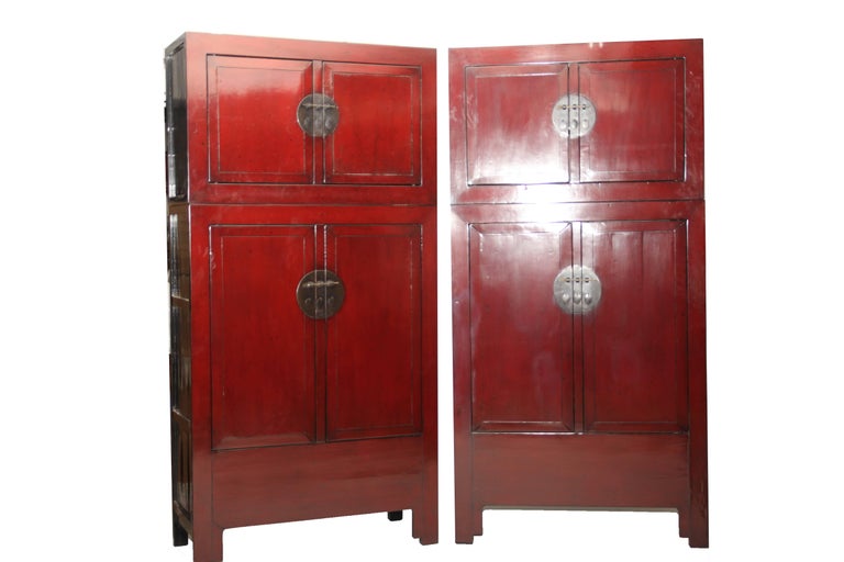 Of rectangular form, the pair of square corner compound cabinets consisting of two sections, the top section known as hat chest and the lower section cabinet, each section with a pair of paneled doors and a removable middle stile, fitted flush