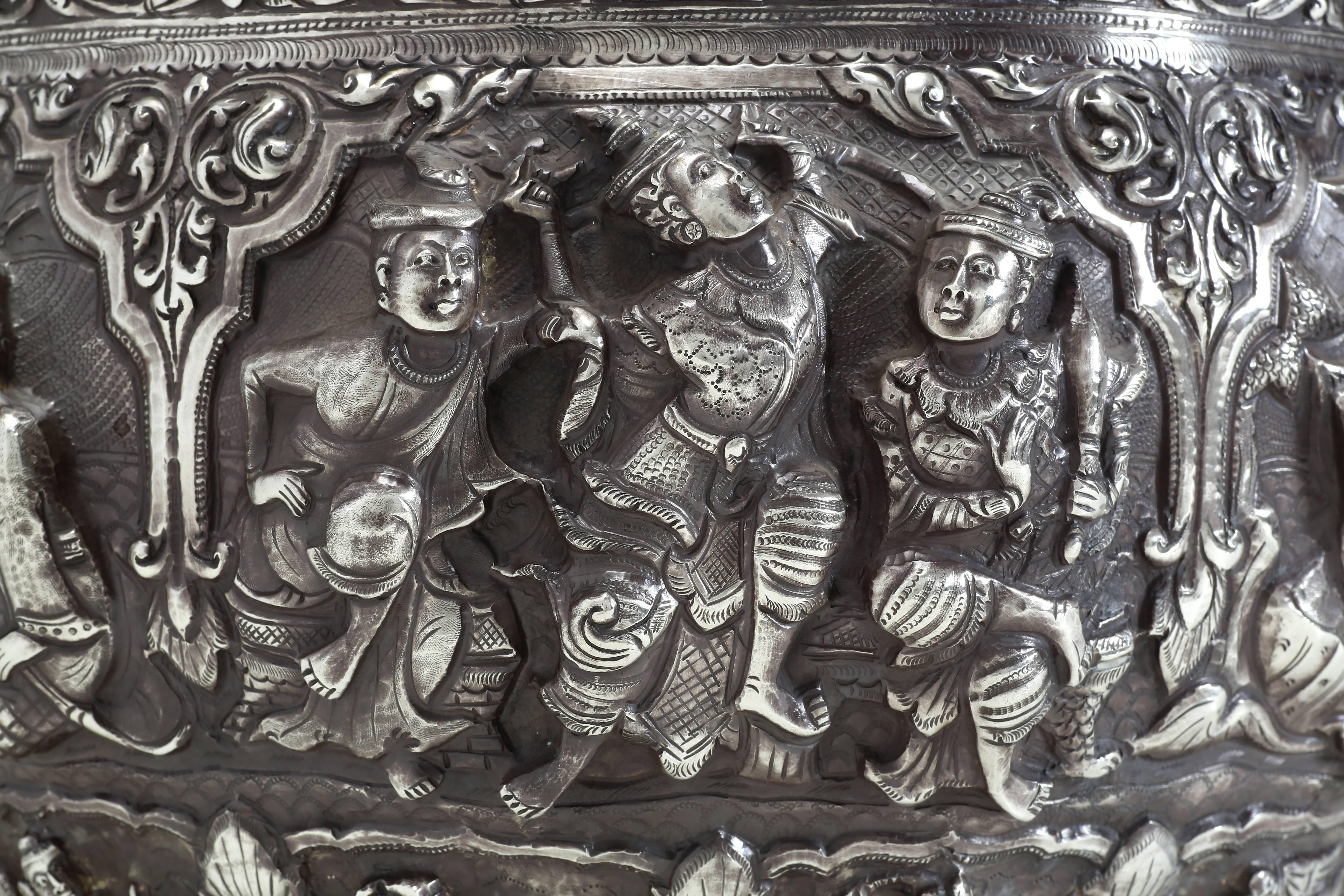The silver bowl with finely chased details in high relief depicts characters from the Jataka tales. These tales are moralistic tales, either from the lives of the Buddha or parables taught by Buddha. The rim of the bowl is finely engraved with