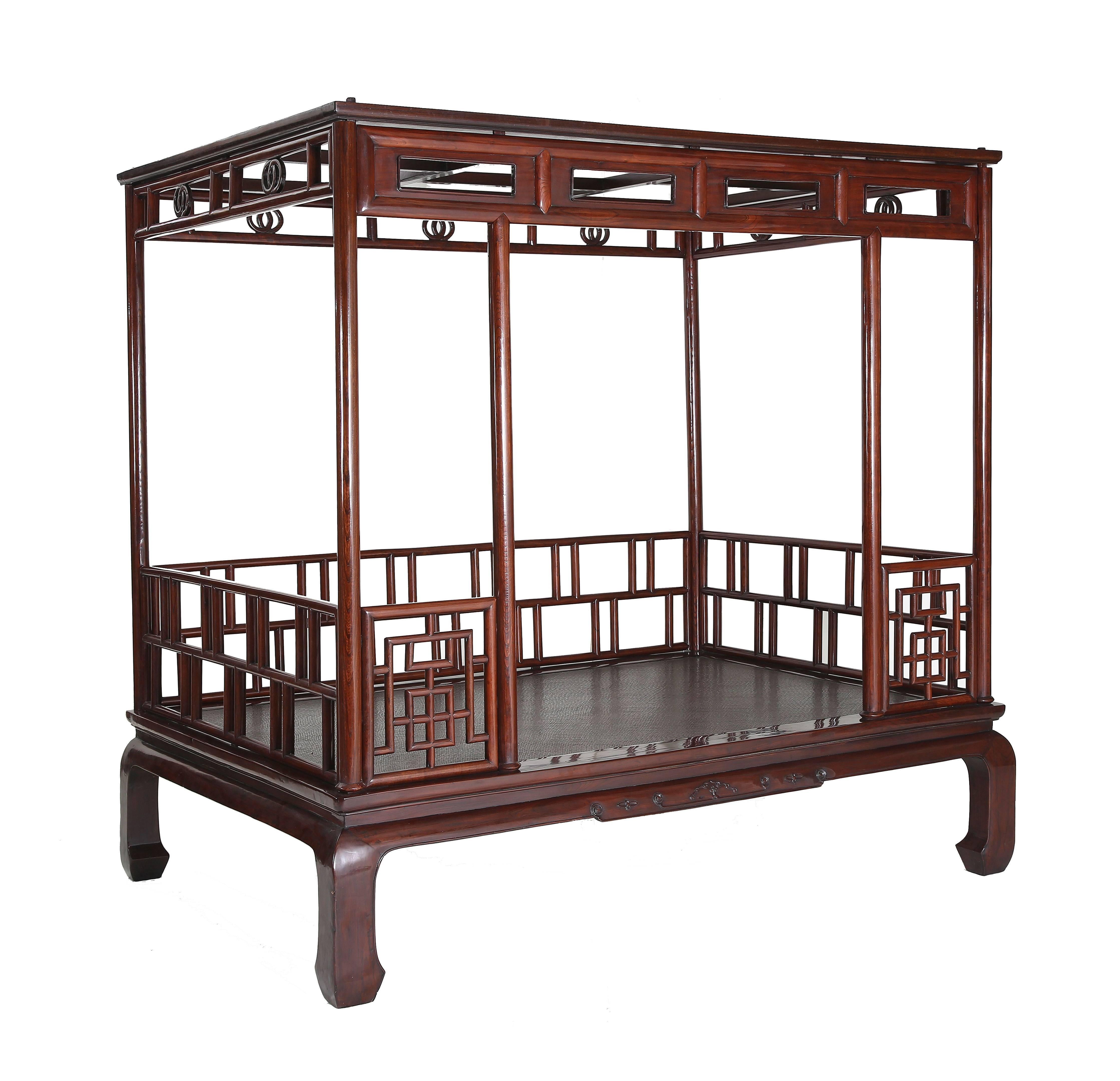 The bed base with a waist, ice-plate edged frame enclosing a cane top, slightly convex aprons with relief-carving and beading continuing to the horse hoof feet, six posts forming the frame for the railings and canopy, decorated with fretwork of