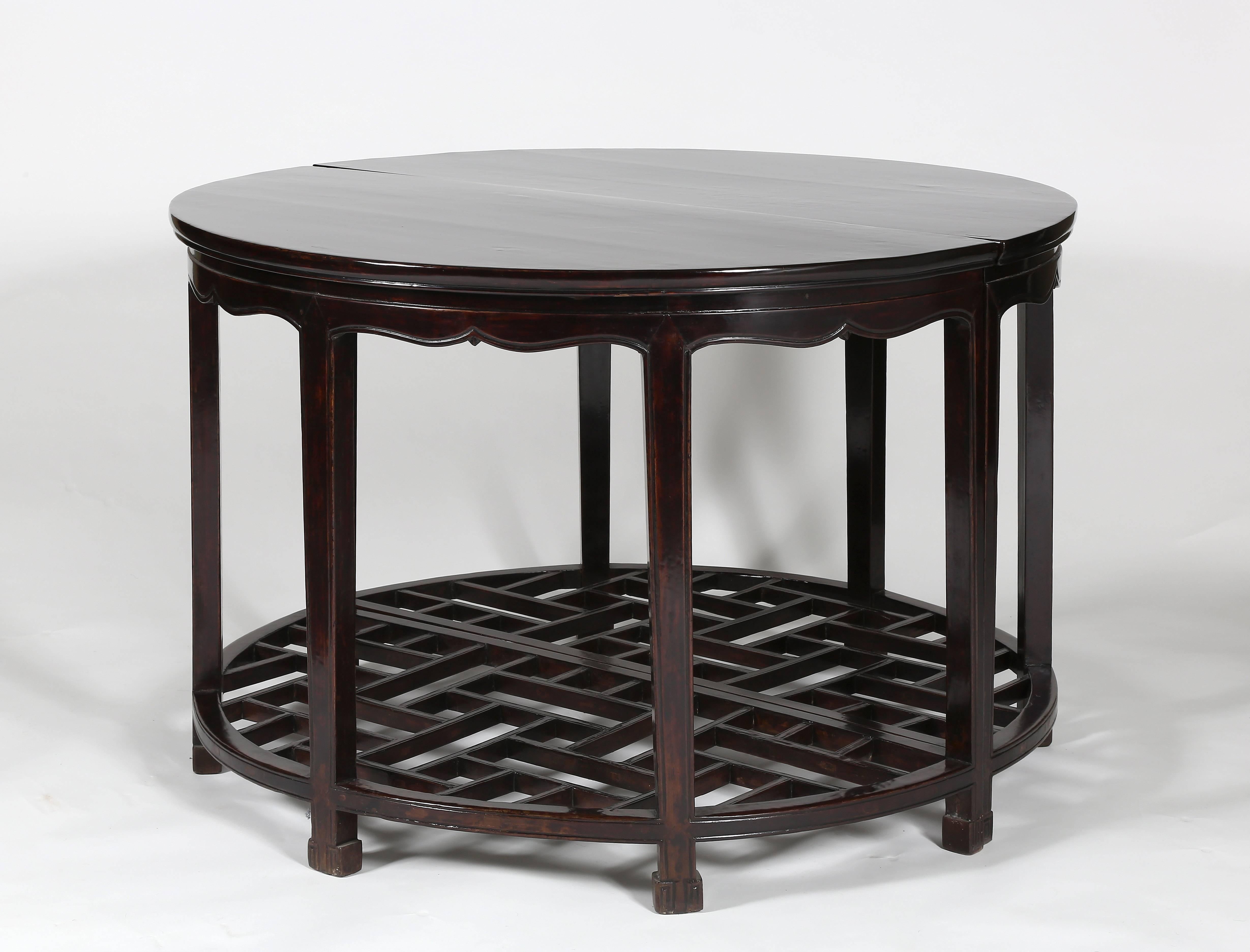 The Fine pair of half-moon tables covered in rich dark lacquer, with solid wood top above a waist, supported on rectangular-sectioned legs decorated with cusped curvilinear aprons, carved with a beading along the edges, the legs braced with a