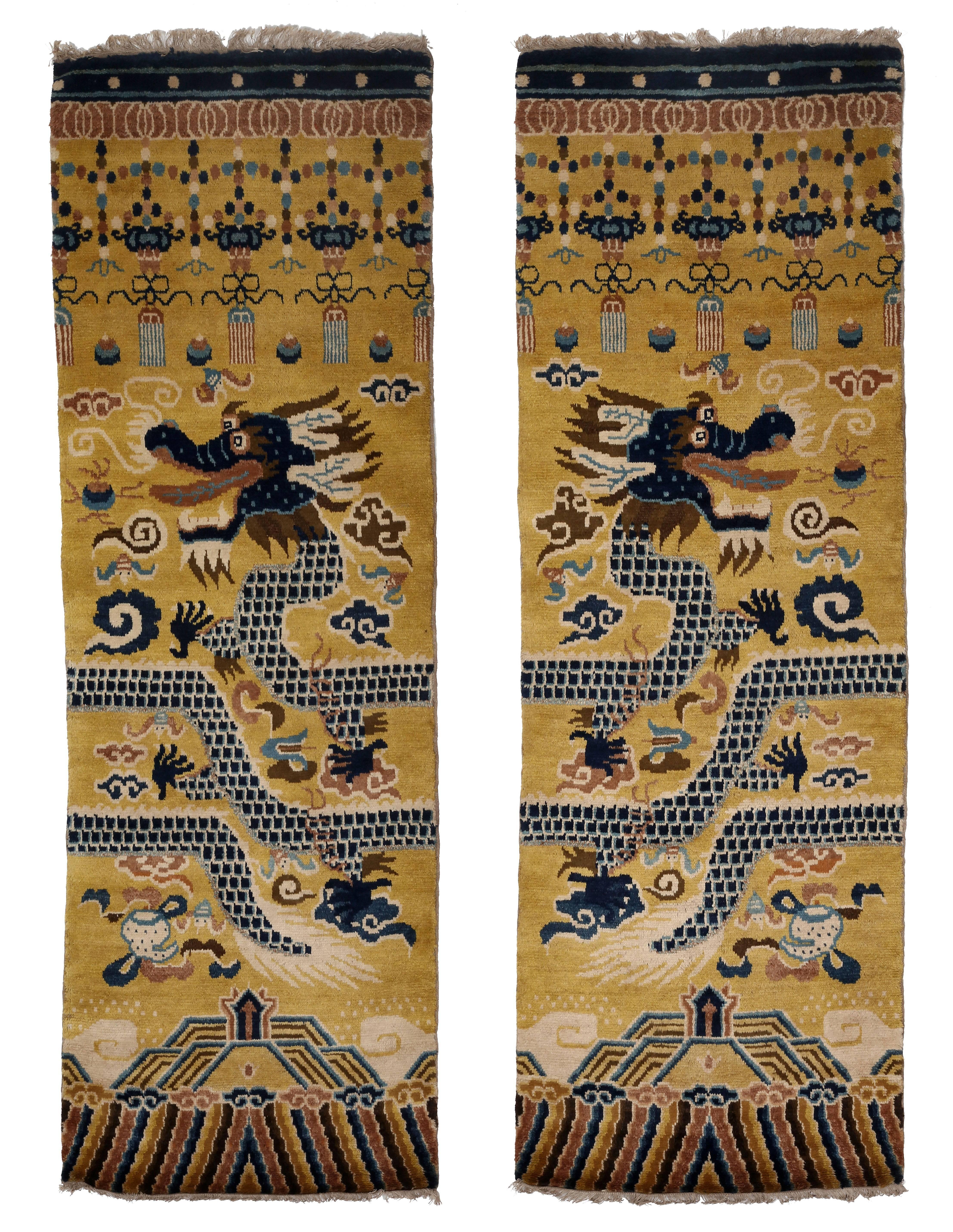 The fine pair of pillar carpets is hand-knotted and woven in the Ningxia style. The autonomous Province of Ningxia shares borders with Mongolia and has a mainly Muslim population thus giving it a rich carpet tradition and access to superb wool. This