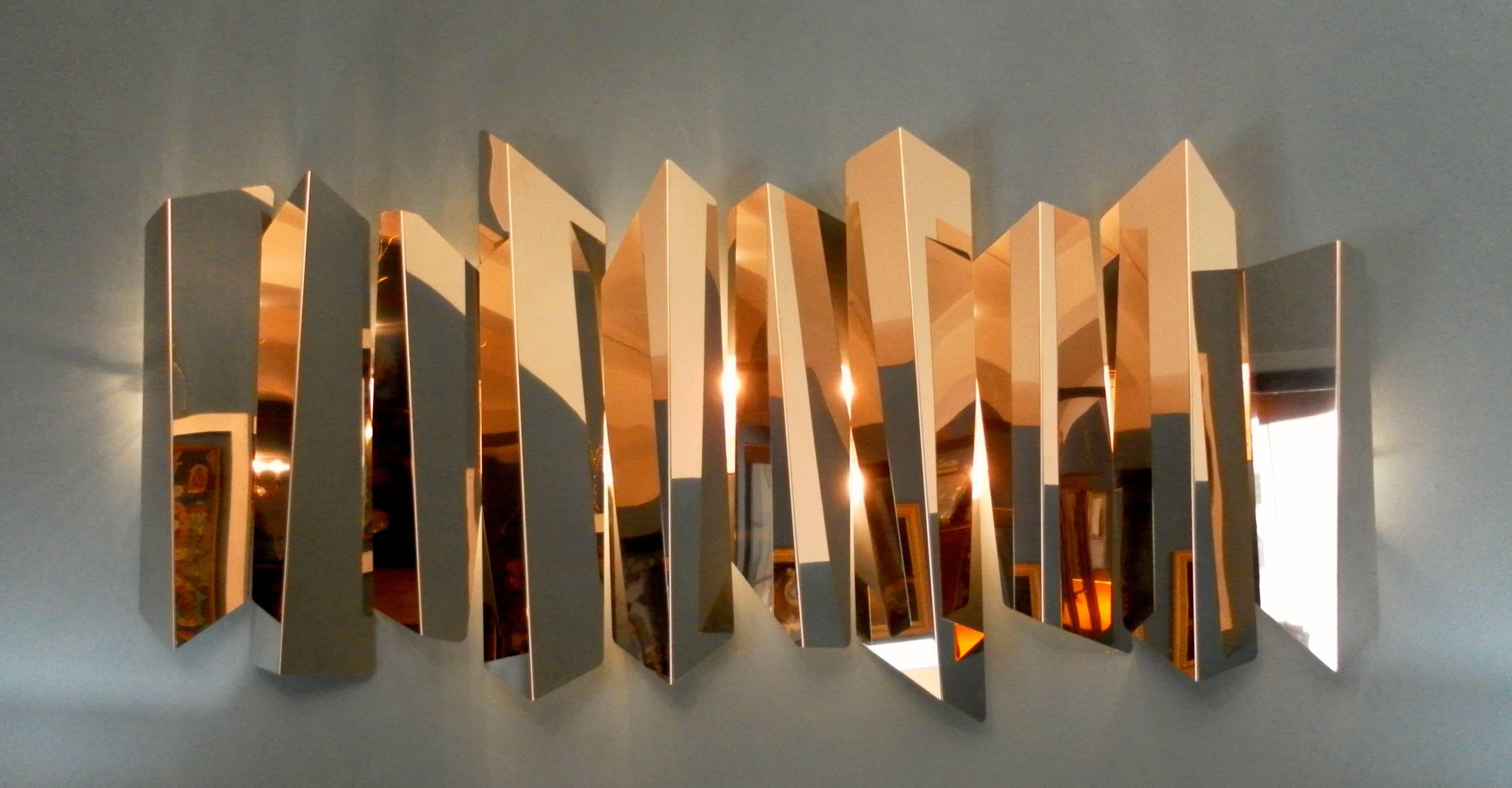 A large and very scenographic  sculptural wall light by Mario Torregiani  In chromed steel.