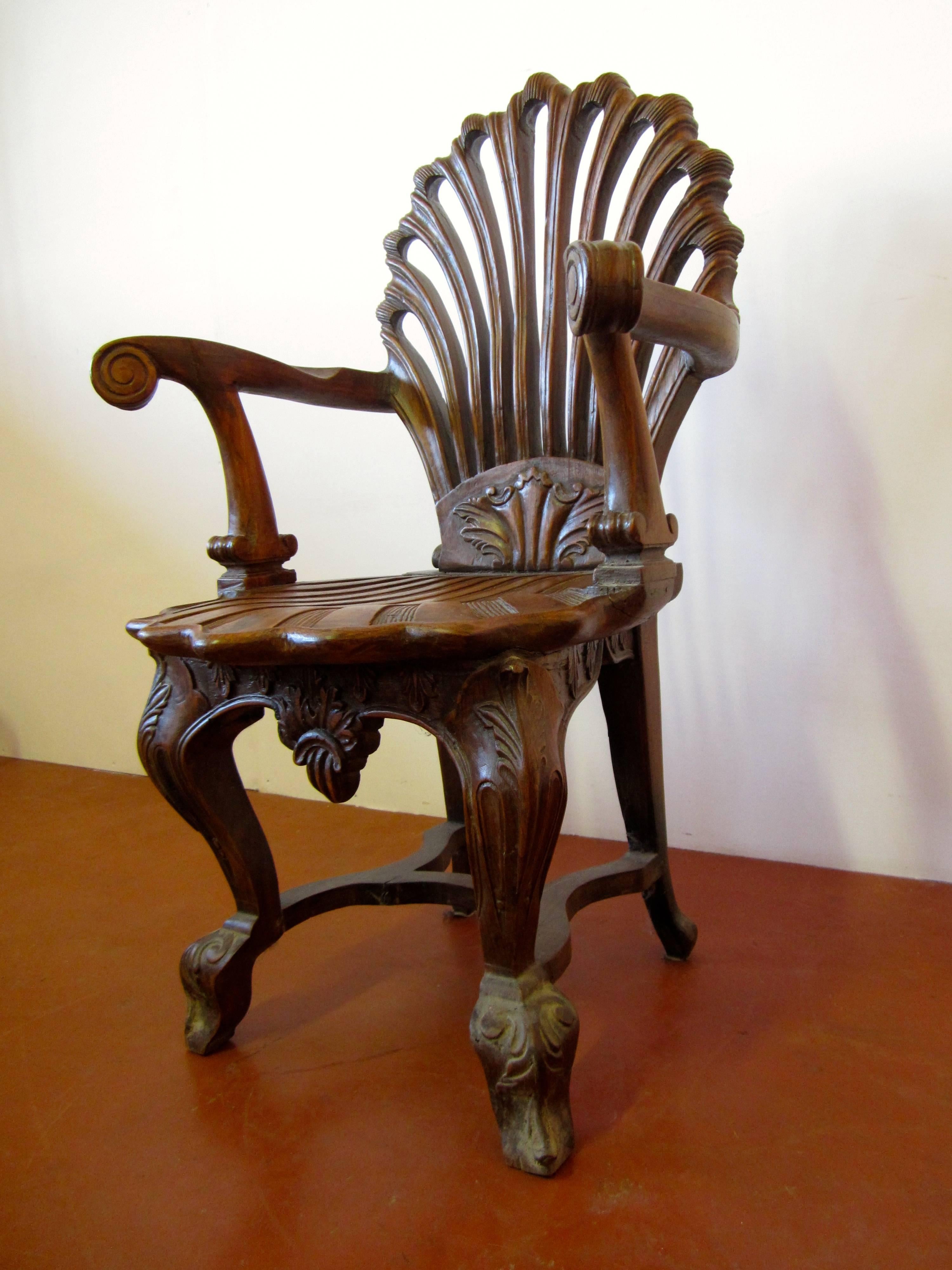 Colonial carved teak wood chair with shell shape.