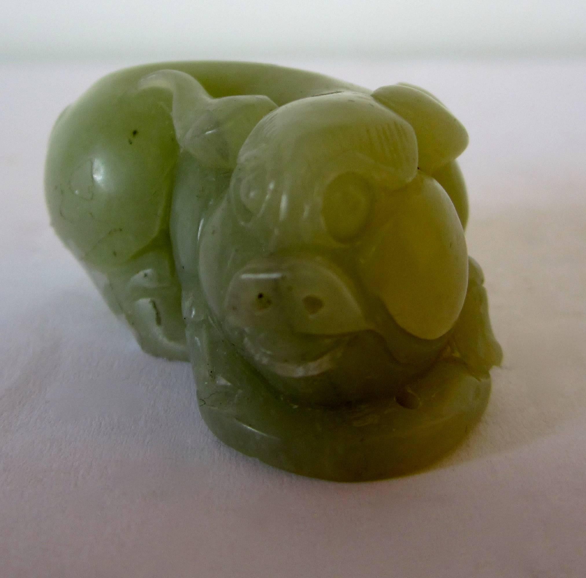 A small green jade figure of a pig, China, early 20th century.
 