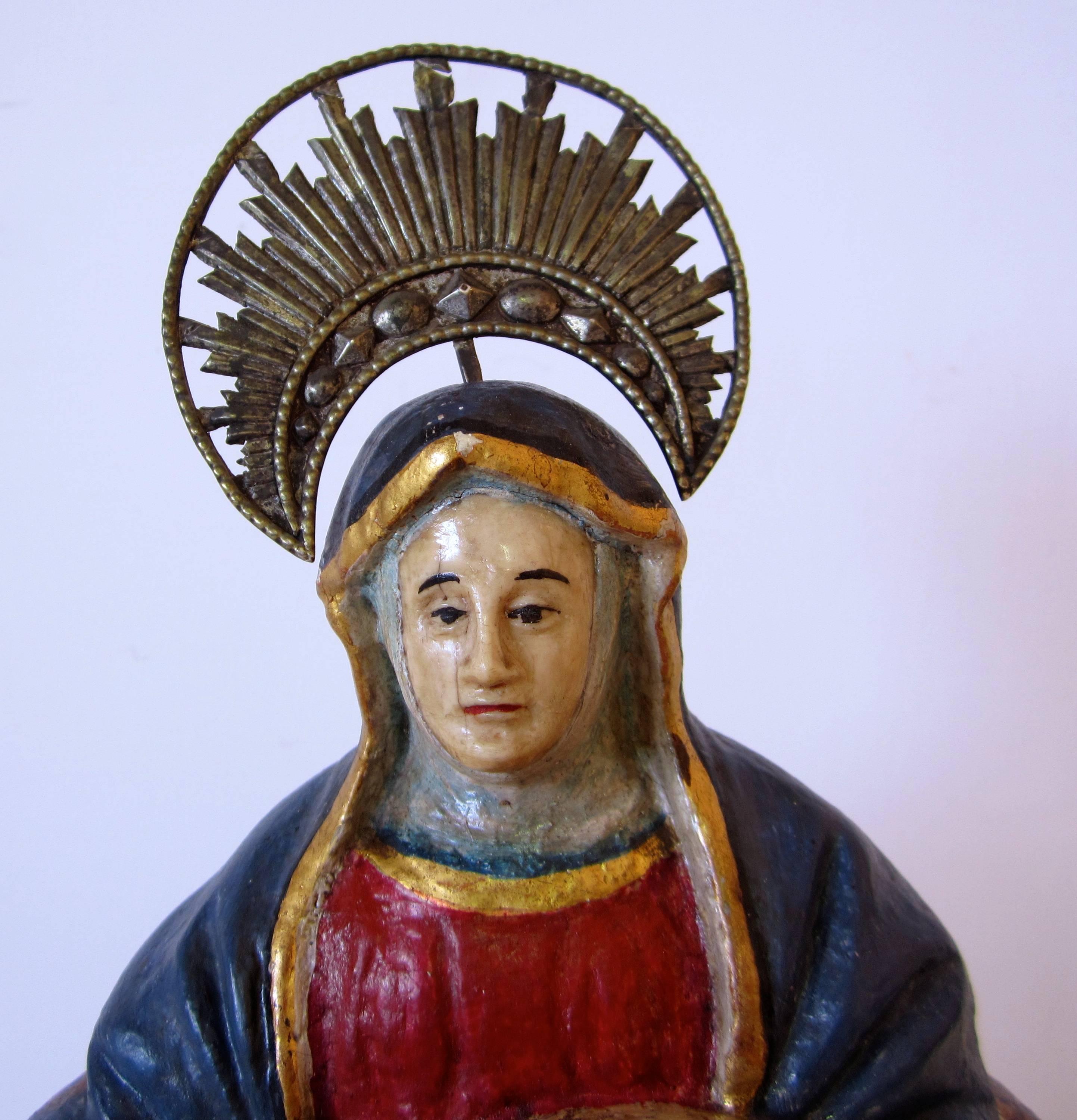 Indo-Portuguese Piedad. The Madonna is holding the dead body of Lord Jesus. Carved, painted and gilded wood with bone face and hands of the Lady Mary, silver cross, Goa, 18th century.
