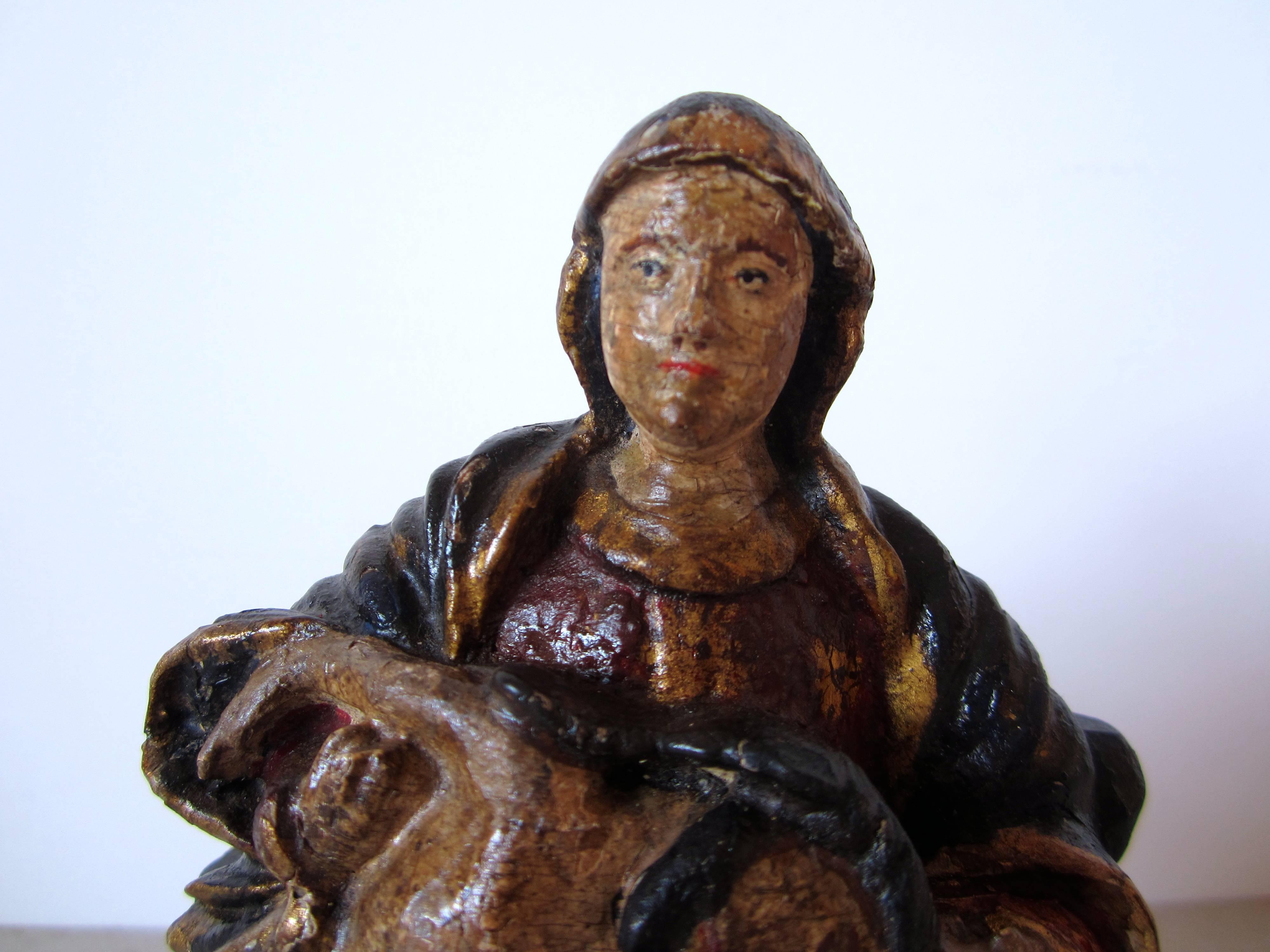 A small Indo-Portuguese Piedad. The Madonna is holding the dead body of Lord Jesus. Carved, painted and gilded wood, back cross is missed, Goa, 18th century.