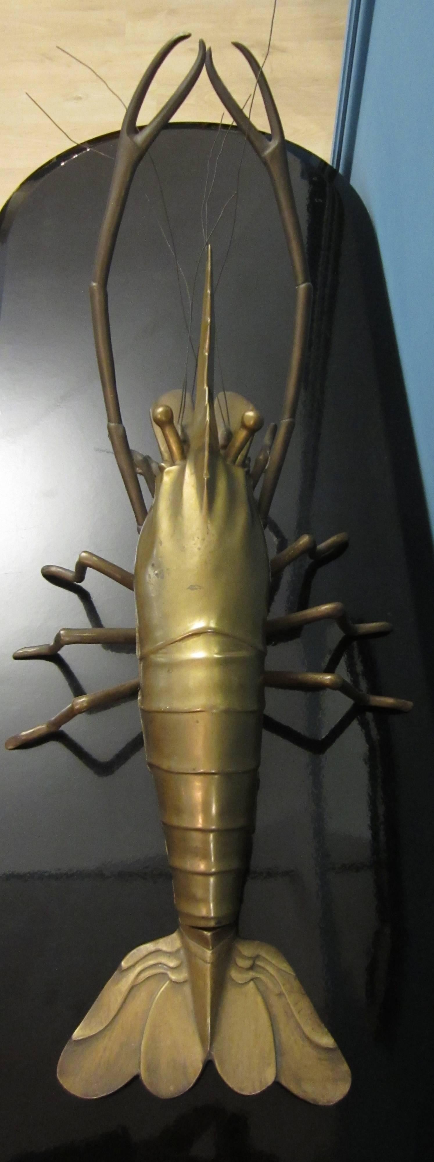 A large sculpture of lobster in gilt bronze. The sculpture is a model of lobster and also a box because it is possible to open it in two pieces, as show in the photos.
  