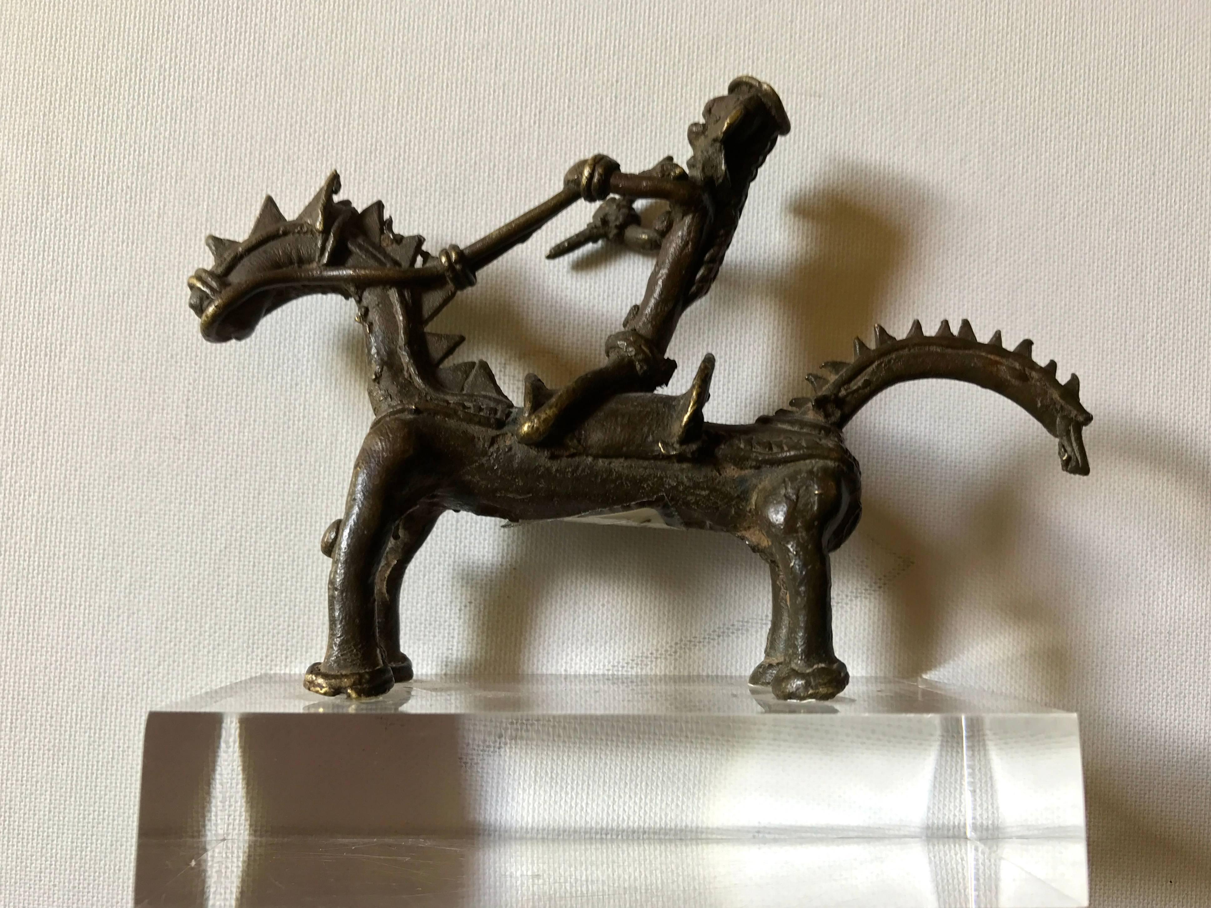 A small Bastar tribal bronze of a rider with a spear on a saddled horse. On a plexiglass base, Orissa, India, late 19th century.