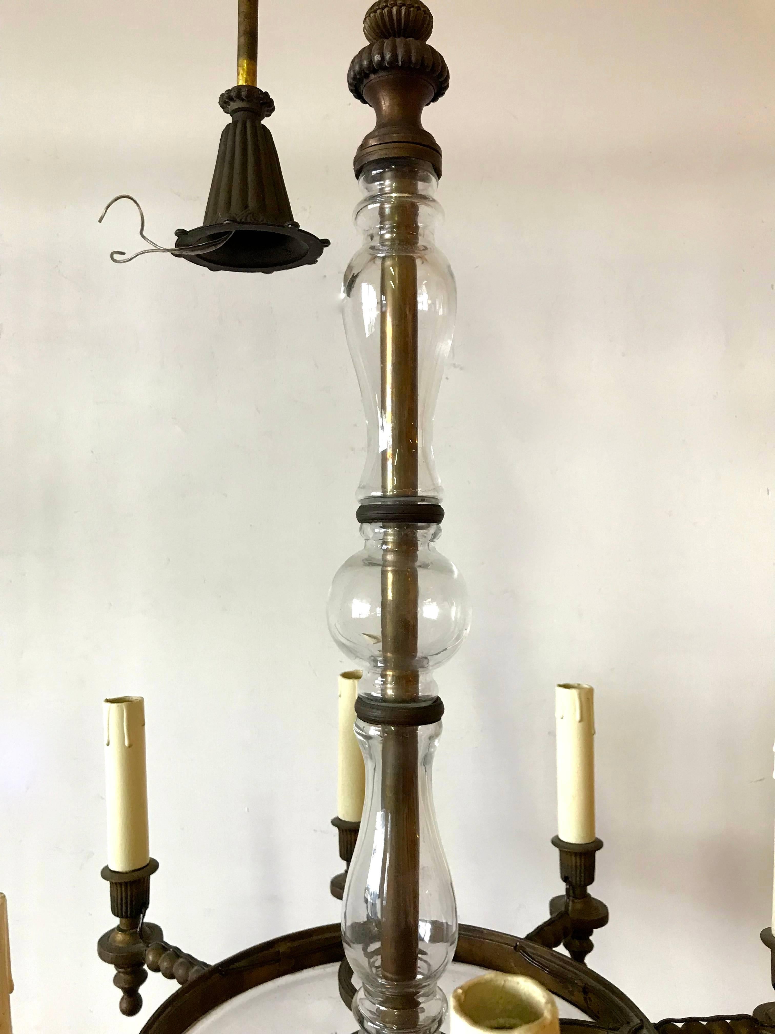 Neoclassical brass and cut-glass chandelier with eight lights. The chandelier is height 80 cm without the chain and and 125 cm with the chain.