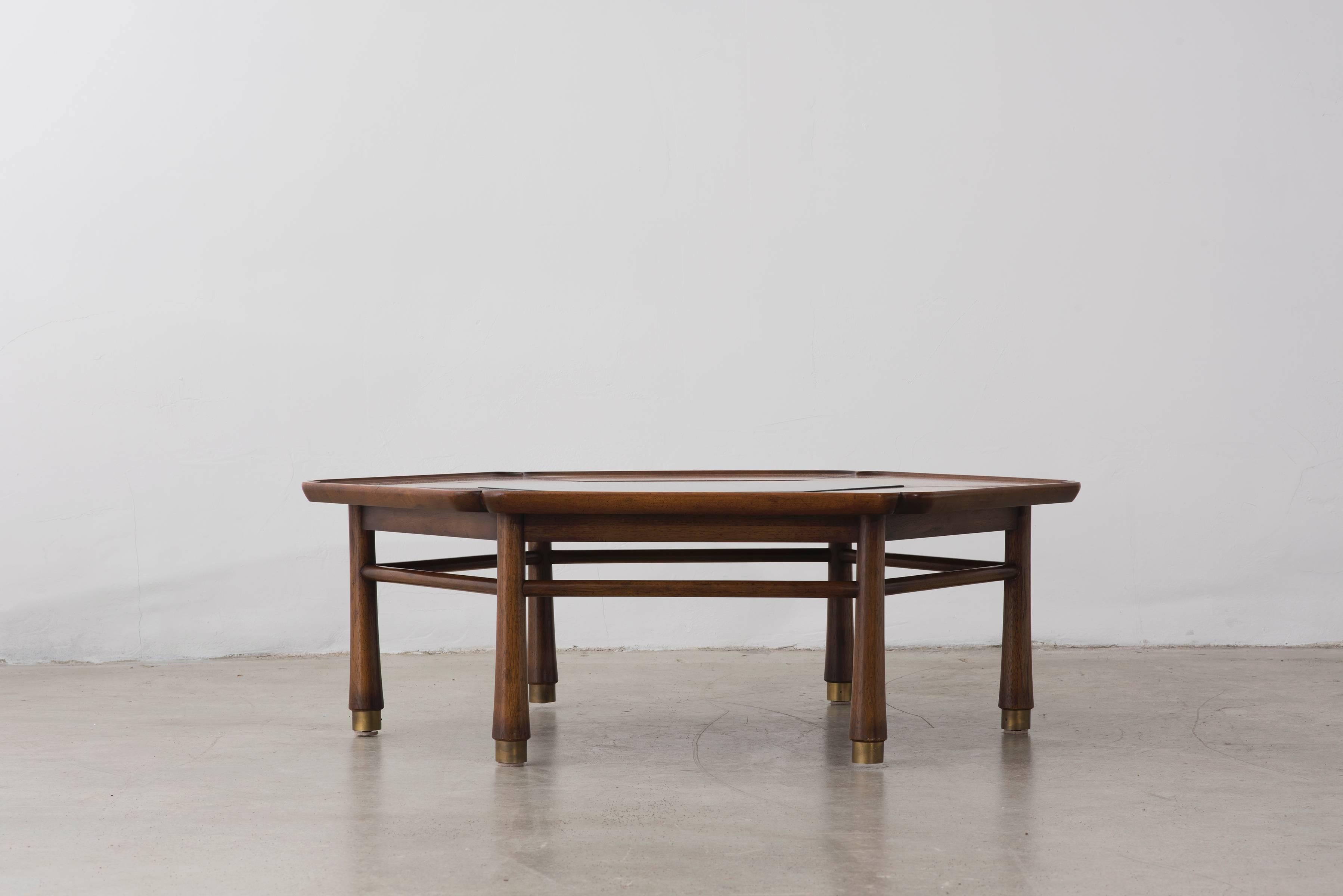 Hexagonal coffee table with Asian detailing to stained oak frame. Center inset with deep green (almost black) Italian granite panel. Brass feet. Frame stamped with 