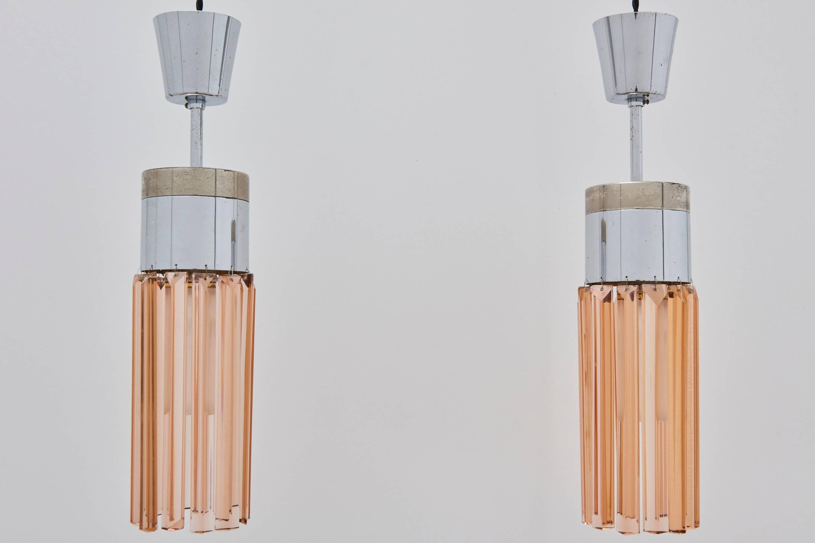 Vintage Pair of Peach Crystal Pendant Lamps, Model No. 1327 by Stilnovo, 1960s. Pair of delicate pendant lamps with chrome-plated metal fittings and long peach-colored faceted glass crystal prisms. One lamp retains original Stilnovo sticker.