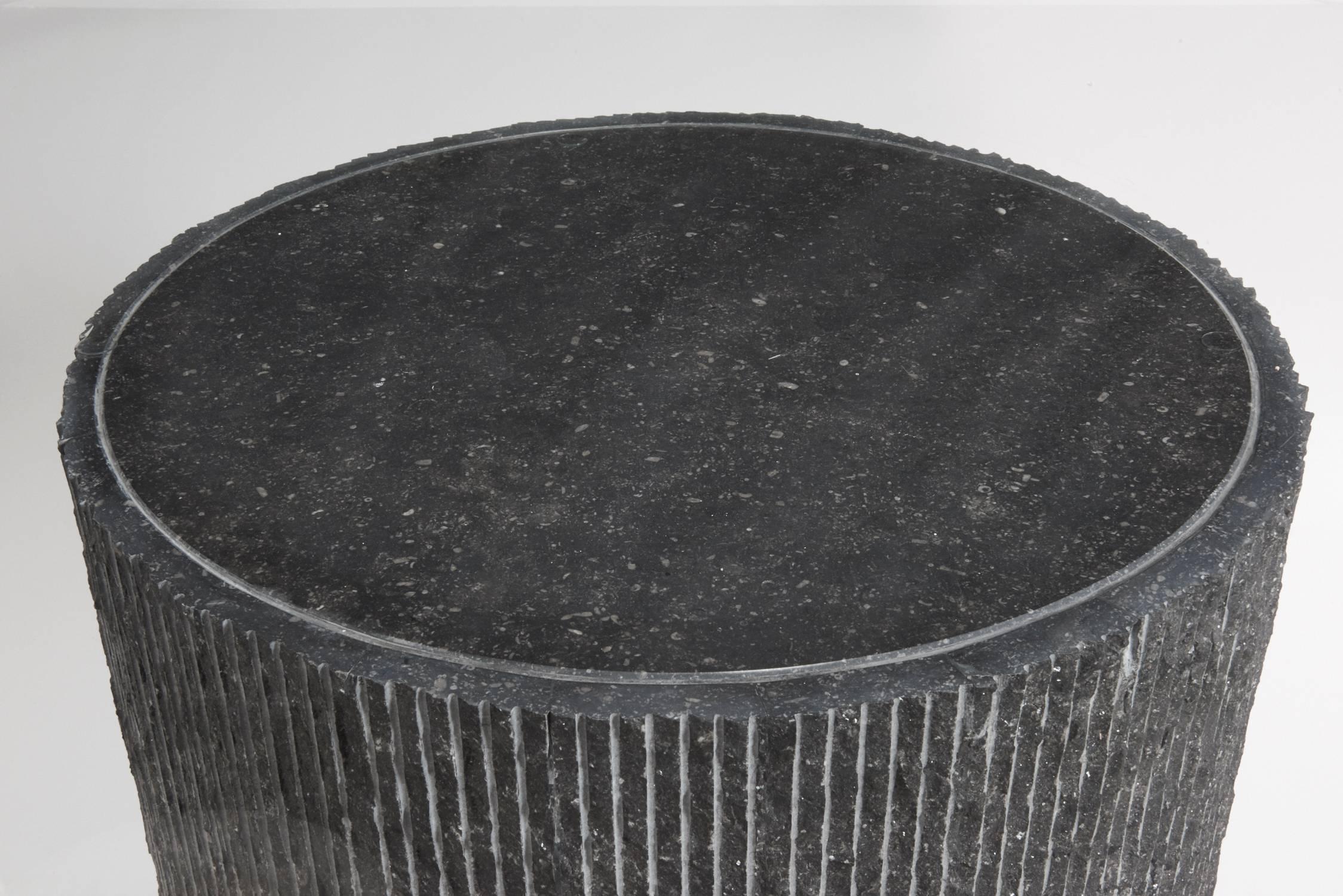 Unique round dining table with sliced granite base and hammer chipped glass top. Base is comprised of thin vertical slices of granite with grouted seams. Top with large circular horizontal slice. Very heavy piece, both base and top. In the style of