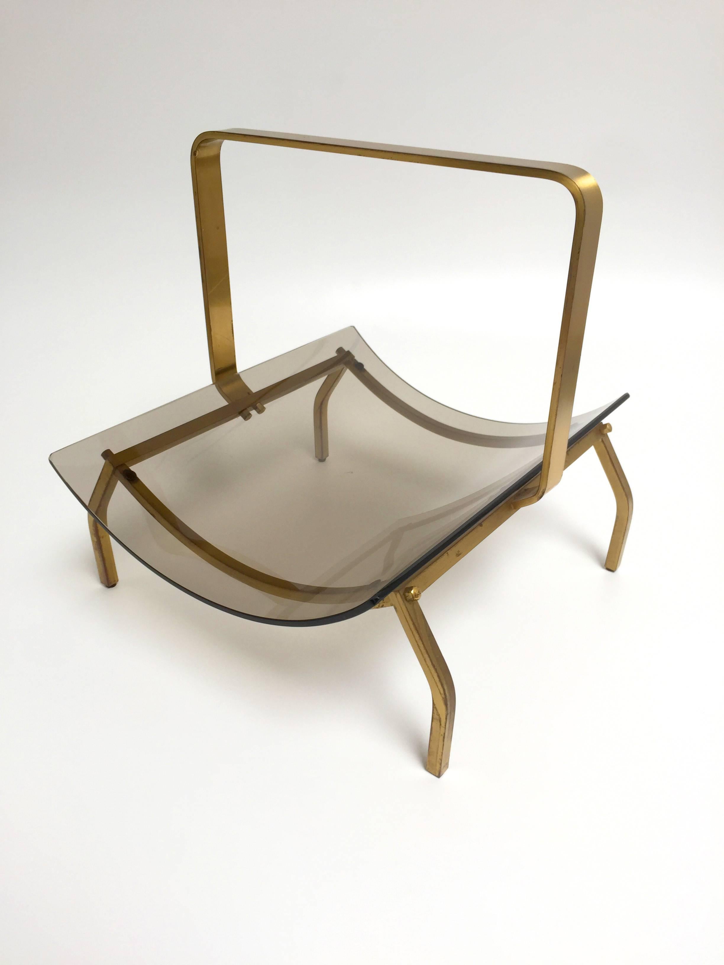 Fontana Arte magazine rack with smoked glass tray and brass stand.